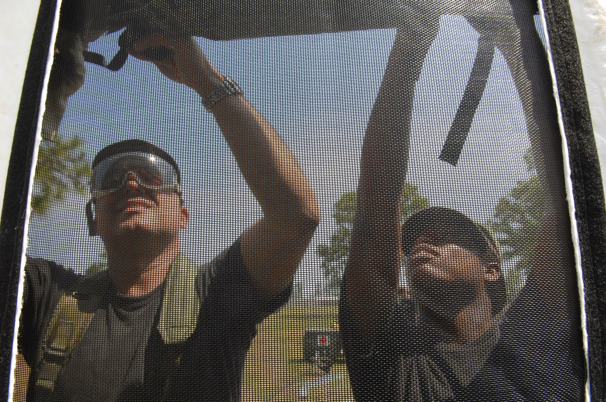 Lt. Col. Antonio Martinez and Senior Airman LaKesha Bryant help put up an Alaskan Medical Shelter by lashing down window and door flaps during "Golden Medic 2007" in Augusta, Georgia. The Army Reserve sponsors the yearly medical exercise to provide realistic training for combat support and service support units. The exercise is designed to enhance the overall training and readiness of Army and Air Force medical units. Colonel Martinez is from the 156th Medical Group at Muniz Air National Base, Puerto Rico, and Airman Bryant is from the 177th Fighter Wing at Atlantic City Airport, N.J. (U.S. Air Force photo/Senior Airman Erica J. Knight)