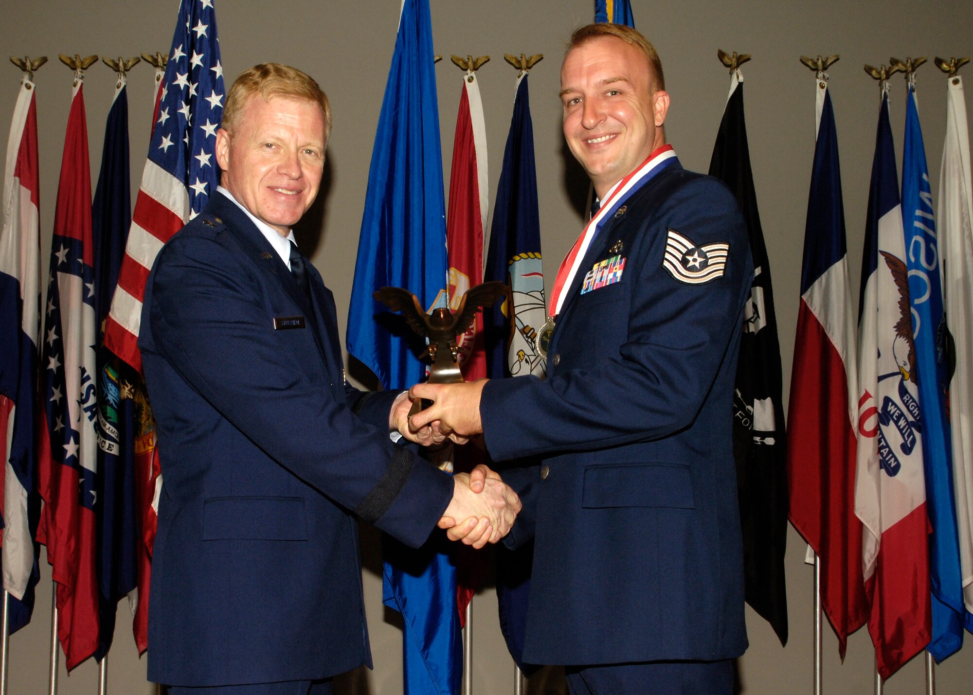 Brig. Gen. Lawrence Stutzriem, Director of Weather, Deputy Chief of Staff for Air, Space and Information Operations, Plans and Requirements, Headquarters U.S. Air Force, and US AF Deputy to National Oceanic Atmospheric Administration, Washington, D.C., presents the 2006 Non Commissioned Officer AF Weather award to Tech. Sgt. Jeff Hall, 22nd Operations Support Squadron, at the Women’s Memorial in Washington, D.C., May 22. 