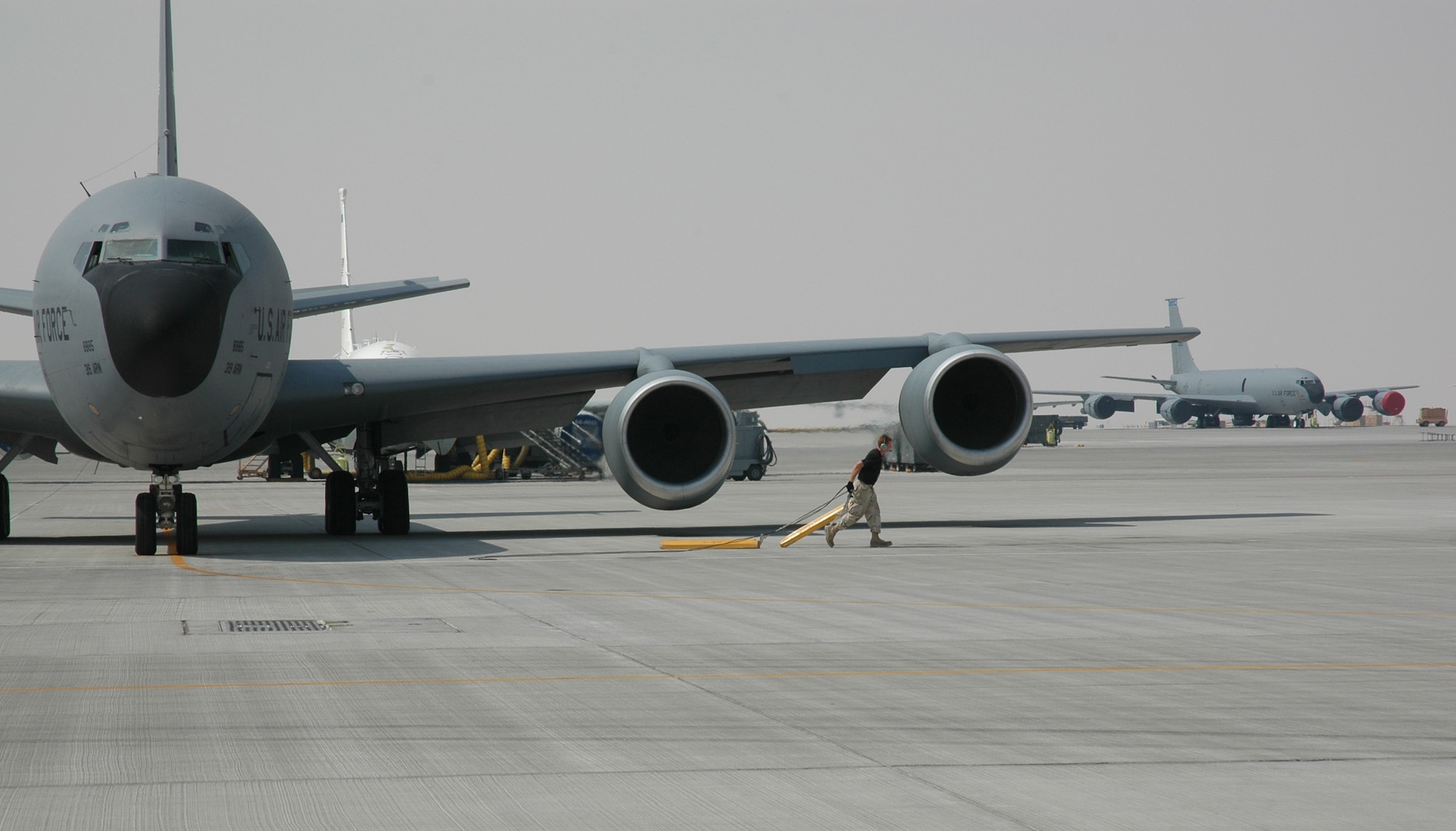 A maintainer pulls the chocks as an Air Force KC-135 Stratotanker prepares to depart on a refueling mission over Southwest Asia. Coalition tanker aircraft flew 48 sorties June 12 and refueled 242 aircraft. (U.S. Air Force photo.) 

