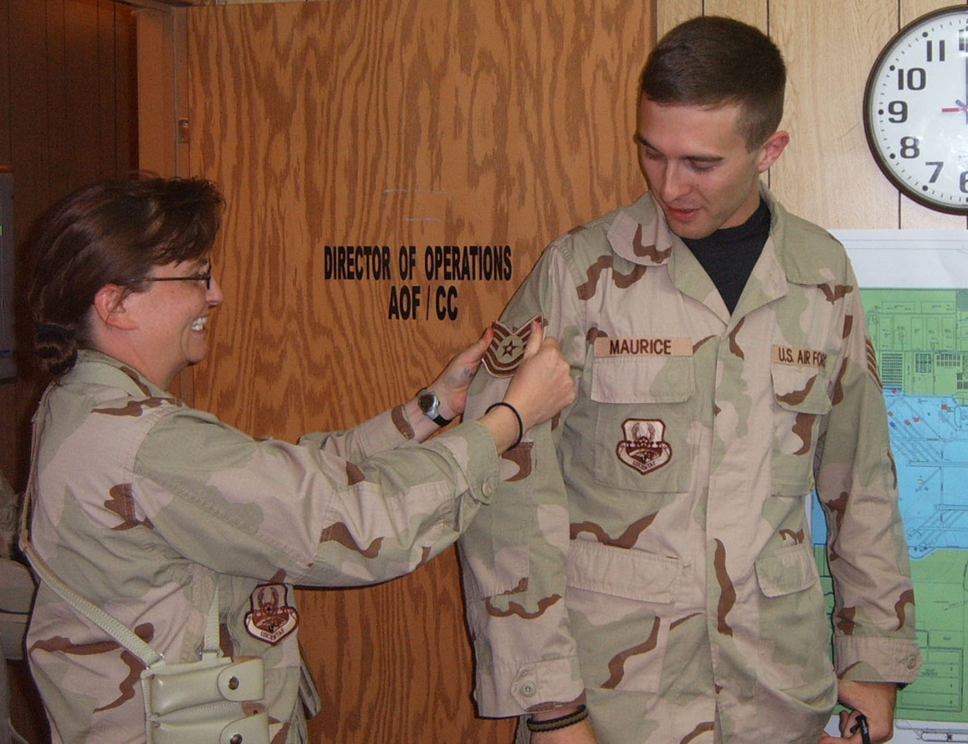 Capt. Heather Labarge, 407th Operations Support Squadron, tacks on technical sergeant stripes to Staff Sgt. David Maurice, during their deployment to Ali Air Base, Iraq. Sergeant Maurice is deployed from the 12th OSS. More than 130 Randolph staff and technical sergeants were selected for promotion.. (U.S. Air Force photo by Staff Sgt. Lindsey Maurice)