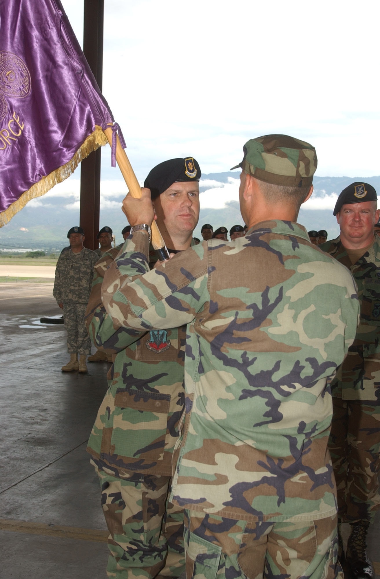 Accepting the Joint Security Forces guidon from Lt. Col. Howard Jones, Joint Task Force-Bravo deputy command,  Maj. John Swift assumes command of JSF at Soto Cano Air Base, Honduras June14.  Major Swift arrived from Scott Air Force Base, Ill., where he served as Training Branch and Force Protection Inspections chief in the Office of the Inspector General, Headquarters Air Mobility Command.  U.S. Air Force photo by Martin Chahin.                      