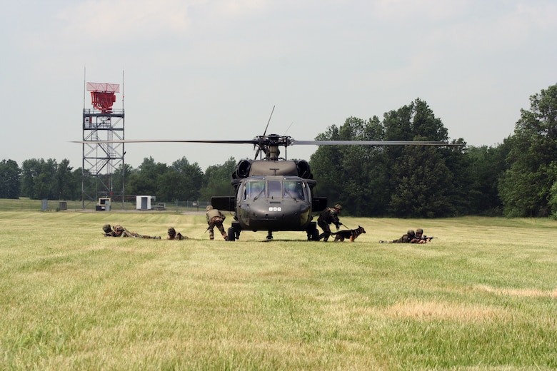 Members of the 509th Explosive Ordnance Disposal flight and Security Forces Squadron unload from a UH-60 Blackhawk June 7 during a week-long training scenario here. Part of a Joint Service training operation, the 1-106 Aviation Assault Battalion from Fort Leonard Wood provided the helicopter to give Airmen a more realistic experience. (U.S. Air Force photo/Staff Sgt. Jason Barebo)