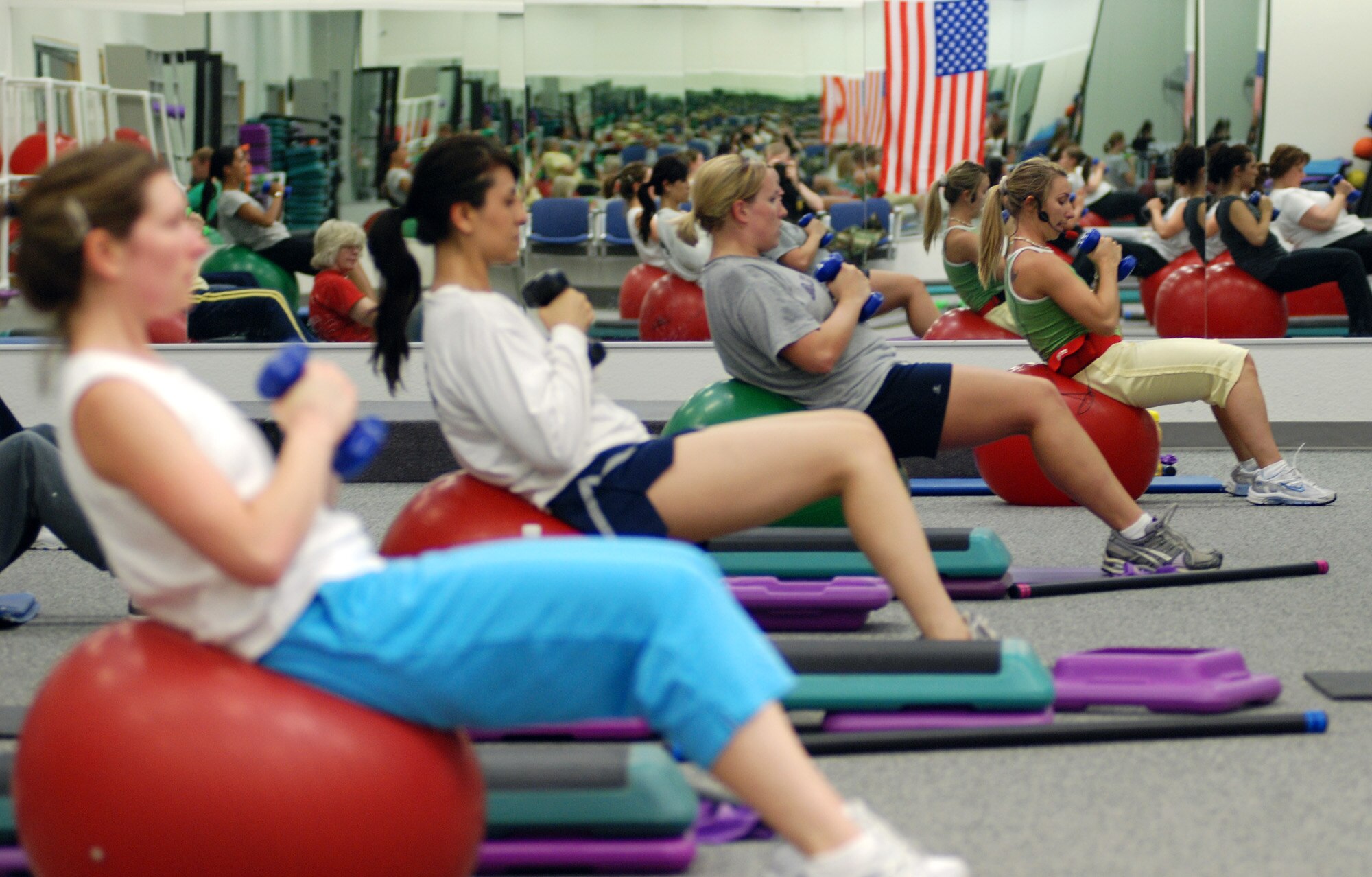 FAIRCHILD AIR FORCE BASE, Wash. – Members of the "Butts and Guts” fitness class conducted at the fitness center here perform weighted crunches using an exercise mobility ball. The 60-minute class, taught by fitness instructor Megan Shelby, is held Mondays and Wednesdays at 4 p.m. (U.S. Air Force photo / Tech. Sgt. Larry W. Carpenter Jr.)