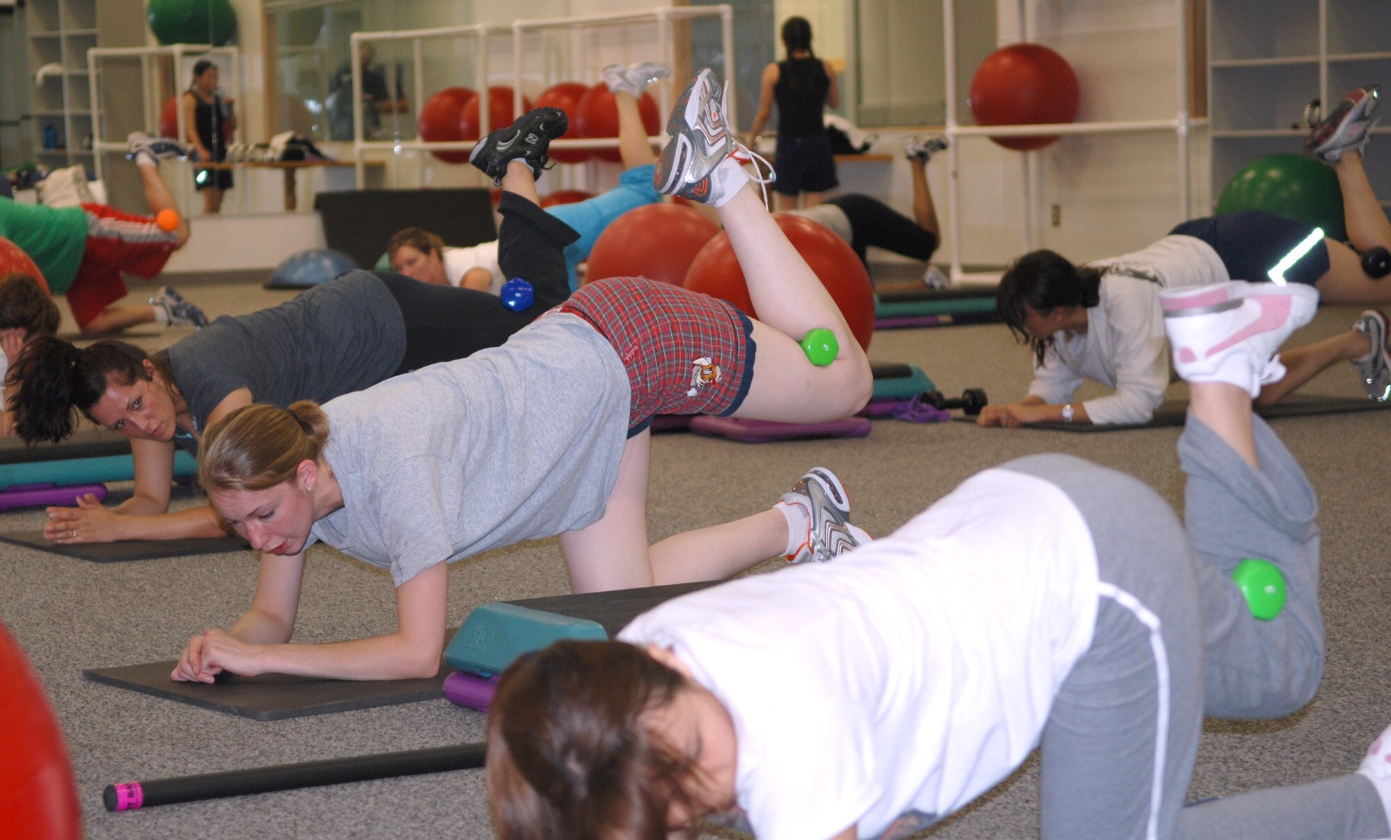 FAIRCHILD AIR FORCE BASE, Wash. – Members of team Fairchild participate in a exercise class at the fitness center here on June 11. The class, called “Butts and guts,” consists of sixty minutes of exercises. Half of that time is spent on glutes, hamstrings and the lower back, and the remaining time focuses on abdominals and stretching. (U.S. Air Force photo / Tech. Sgt. Larry W. Carpenter Jr.)