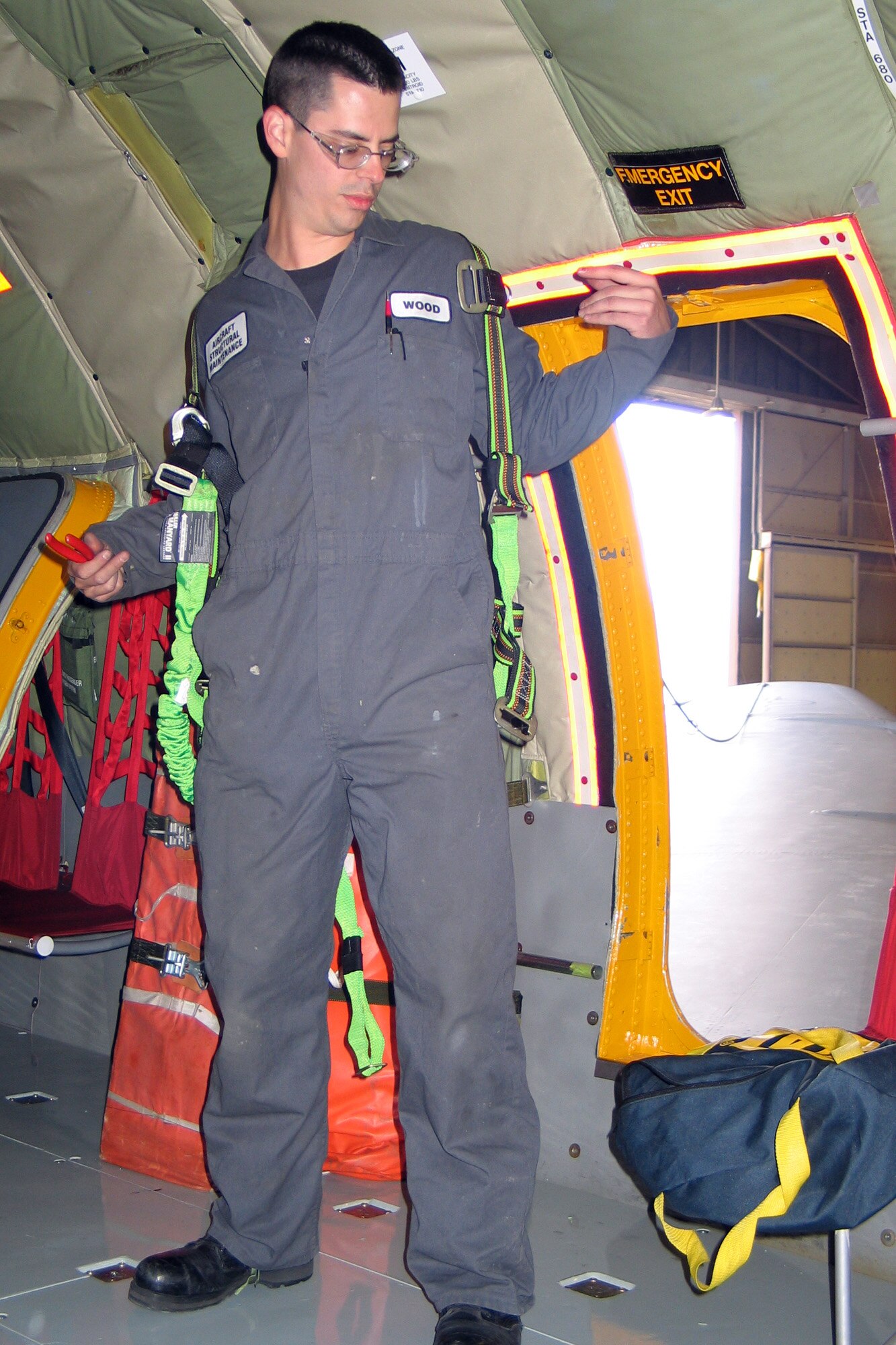 FAIRCHILD AIR FORCE BASE, Wash. – Staff Sgt. Josiah Wood, 92nd Aircraft Maintenance Squadron aircraft structural maintenance, takes off his fall protection rope and harness after fit checking a KC-135 wing panel. Sergeant Wood is one of 18 Fairchild Airmen chosen to participate in Air Mobility Rodeo 2007 at McChord Air Force Base, Wash., in late July. (U.S. Air Force photo/Staff Sgt. Connie L. Bias)