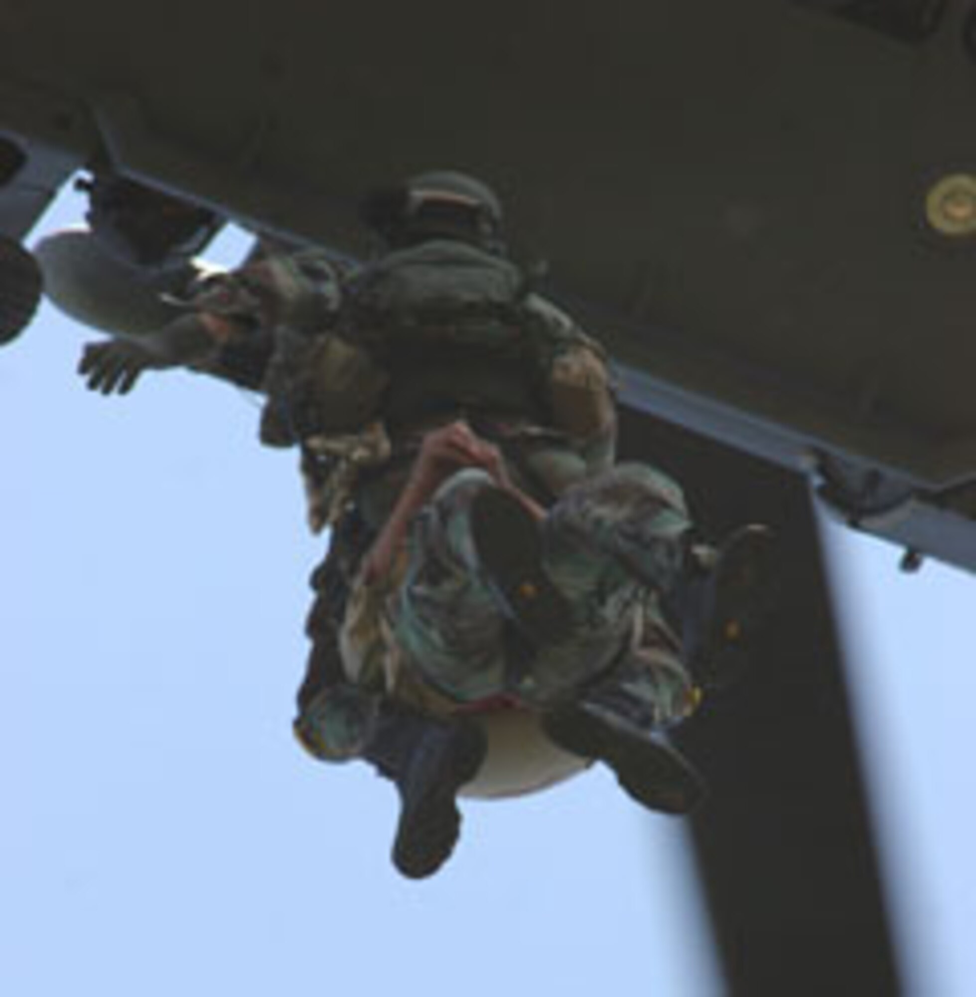 A pararescueman from the 304th Rescue Squadron, Portland, Ore. and Tech. Sgt. Eric Bigelow, 305th Rescue Squadron aircrew life support equipment technician are hoisted into a HH-60 Pavehawk helicopter during a mountain rescue training scenario on a mountain top near Hood River, Ore. June 9, 2007.  A pararescueman are primary personnel recovery specialist with emergency medical capabilities used in humanitarian and combat environments.  They can deploy by air-land-sea into any environment to rescue or recover injured and stranded people.  (U.S. Air Force Photo/Ruby Zarzyczny)