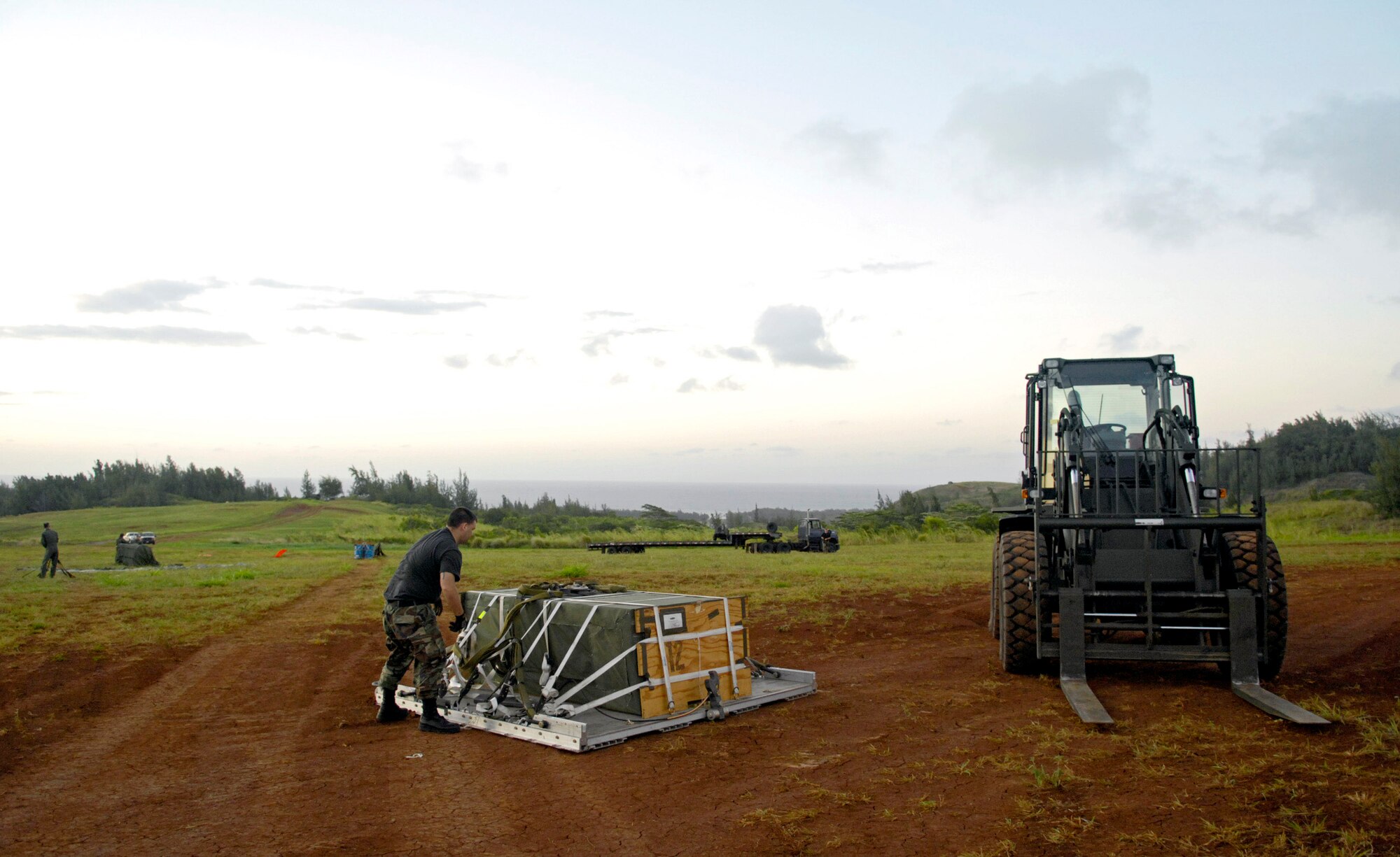 Airman 1st Class Justin Stevens prepares a practice airdrop bundle to be picked up after being dropped from a C-17 Globemaster III June 11 at the Kahuku Training Range in Hawaii. The C-17s, from the 535th Airlift Squadron at Hickam Air Force Base, are being run for quarterly airdrop qualifications. Airman Stevens is an air transportation specialist from the 15th Logistics Readiness Squadron Combat Mobility Element. (U.S. Air Force photo/ Tech. Sgt. Shane A. Cuomo)