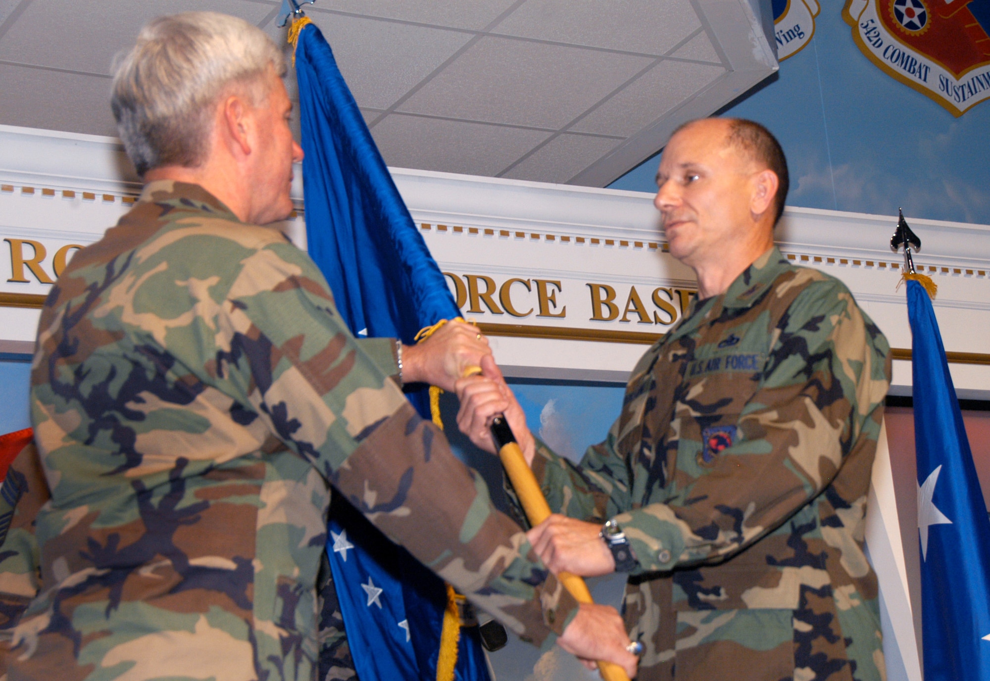 Maj. Gen. Tom Owen, center commander, passes the guidon to Col. Mark A. Atkinson at an appointment of command ceremony Tuesday. Col. Atkinson became the 402nd Maintenance Wing commander. He comes from Randolph Air Force Base, Texas where he served as the Director of Logistics, Installations and Mission Support, Headquarters Air Education and Training Command. U. S. Air Force photo by Sue Sapp    
