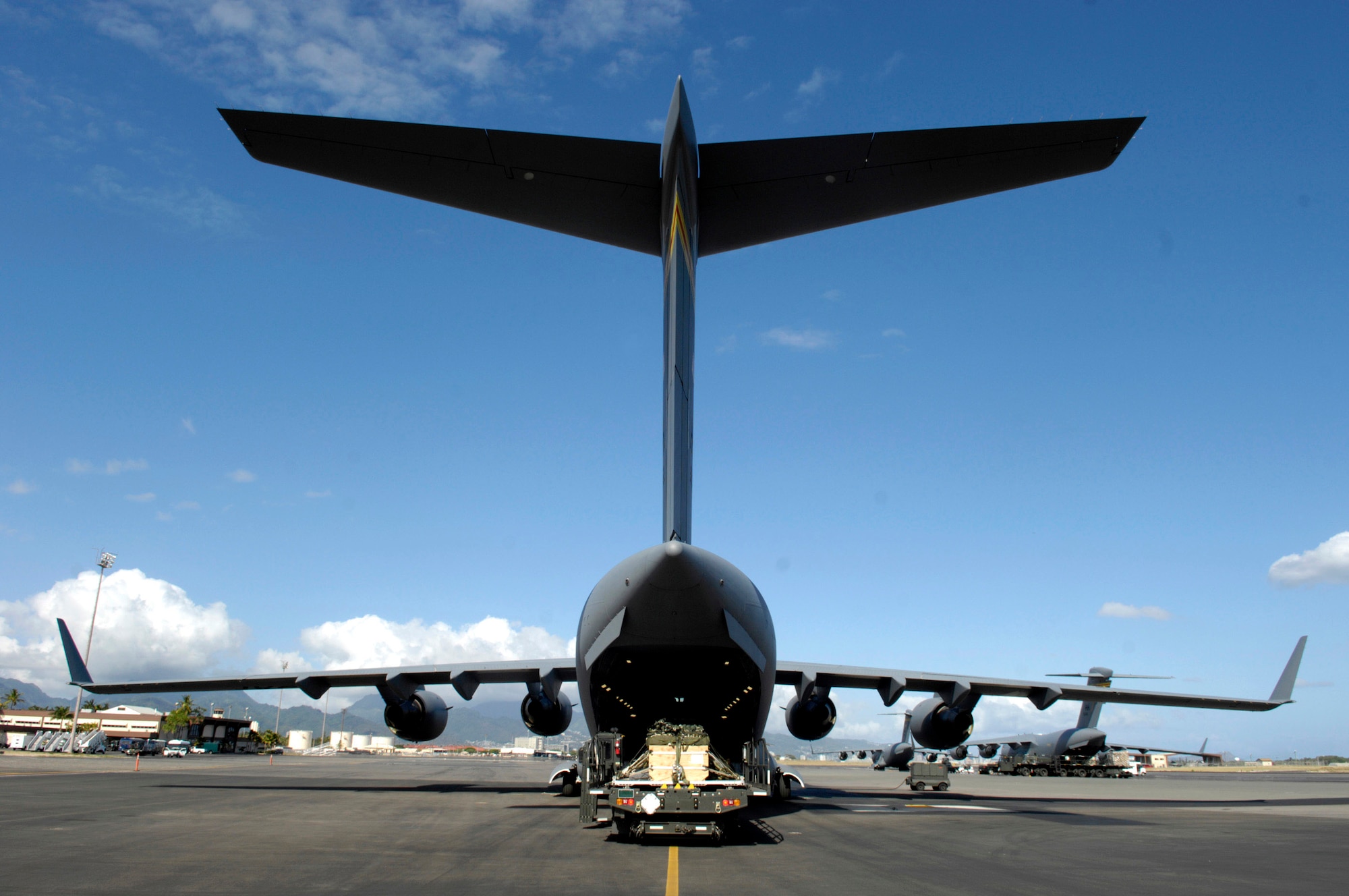 A 15th Logistics Readiness Squadron's K-Loader holds practice bundles ready to be loaded onto a C-17 Globemaster III June 11 at Hickam Air Force Base, Hawaii. The 535th Airlift Squadron is running the C-17's quarterly airdrop qualifications. (U.S. Air Force photo/ Tech. Sgt. Shane A. Cuomo) 
