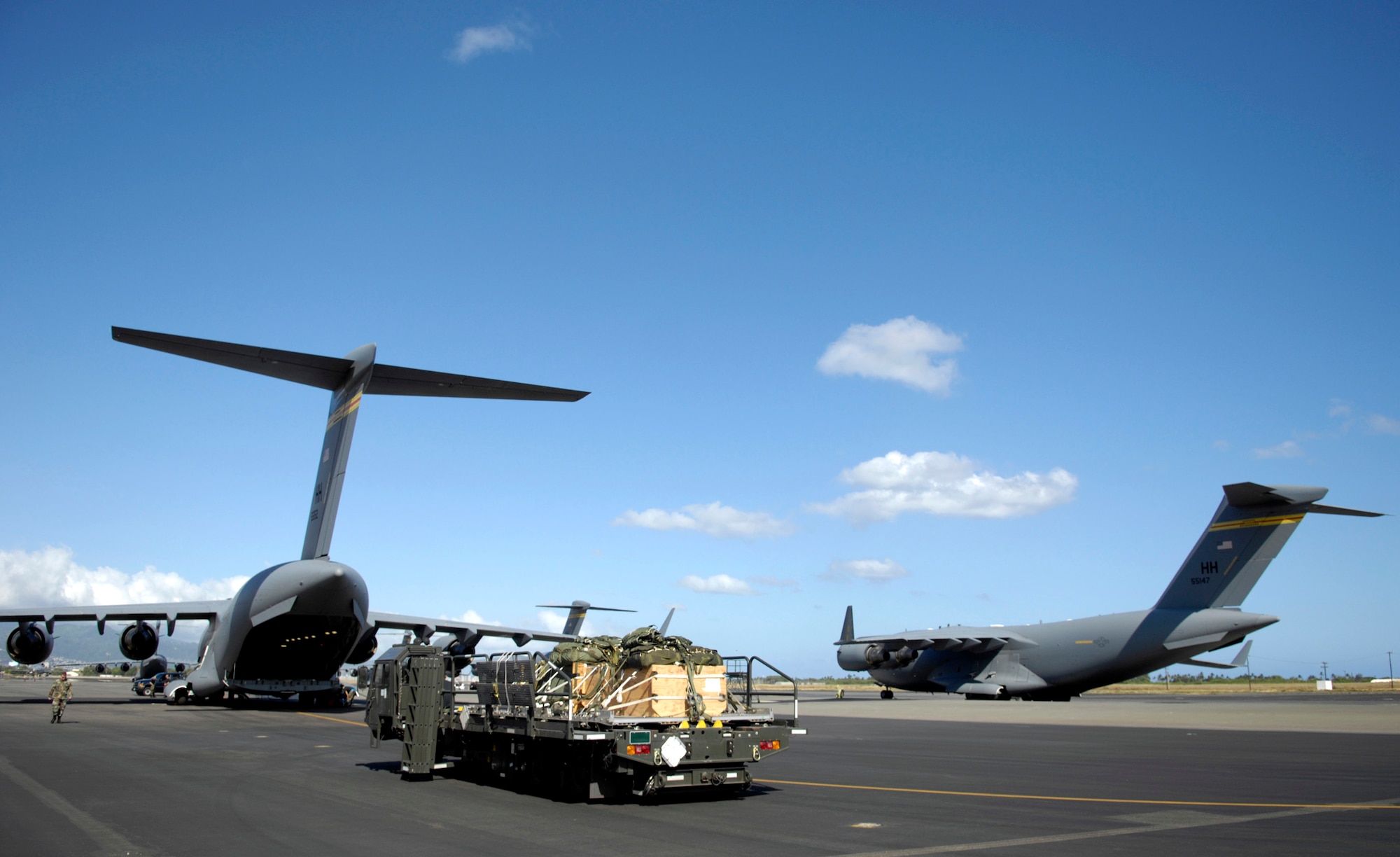A 15th Logistics Readiness Squadron's K-Loader holds practice bundles ready to be loaded onto a C-17 Globemaster III June 11 at Hickam Air Force Base, Hawaii. The 535th Airlift Squadron is running the C-17's quarterly airdrop qualifications. (U.S. Air Force photo/ Tech. Sgt. Shane A. Cuomo) 