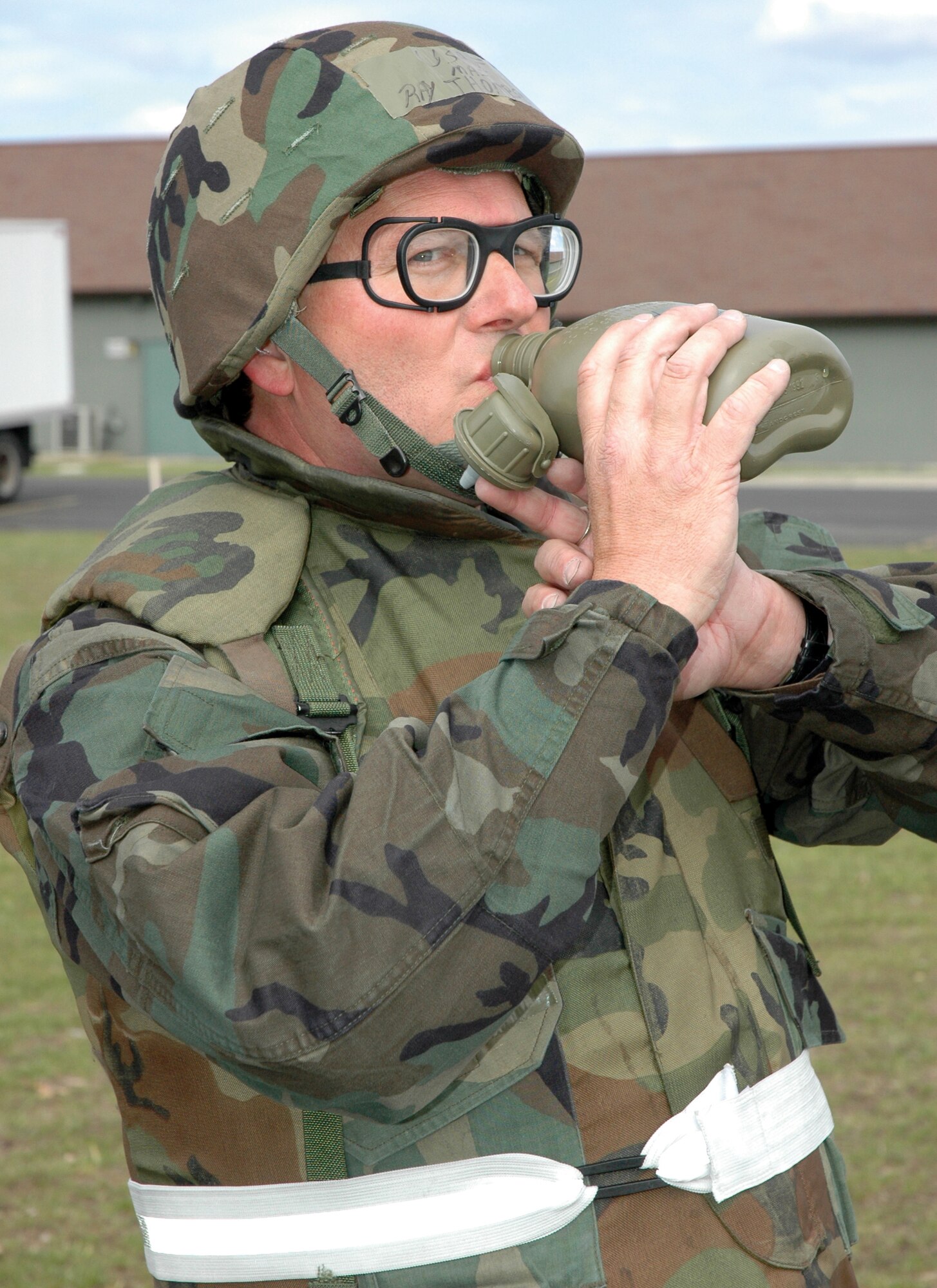 VOLK FIELD, Wis. -- Hydrate -- Hydrate -- Hydrate! Airmen who travelled to Volk Field for training in April got used to the "giant voice" over the public address system calling out this important reminder at least once an hour and then even more frequently as the Mission Oriented Protective Posture Levels increased. Chaplain (Maj.) Ray Thompson, wearing the latest ORI fashions in eyewear and body armor, takes a big swig from his canteen early in the training. (U.S. Air Force Photo/Maj. Chad Gibson)