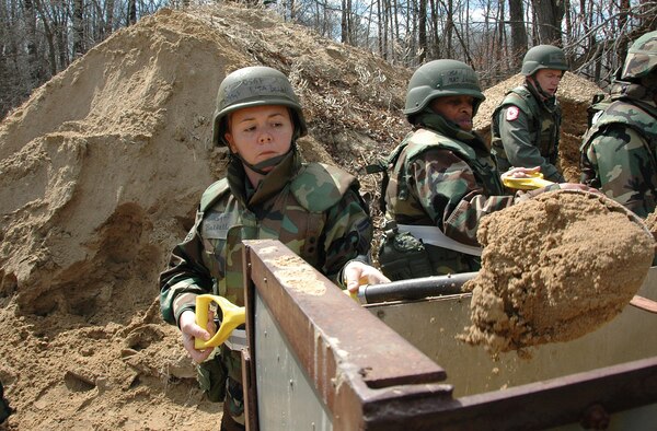 VOLK FIELD, Wis.. -- Members of the 403rd Wing arriving here were greeted with their first official task of the deployment -- filling sandbags. Senior Master Sgt. Lisa Baldelli, NCOIC, 403rd Services Flight, got a little more than her share on the shovel filling six sandbags before she was able to hand it off to the next person. (U.S. Air Force Photo/Tech. Michael Duhe)