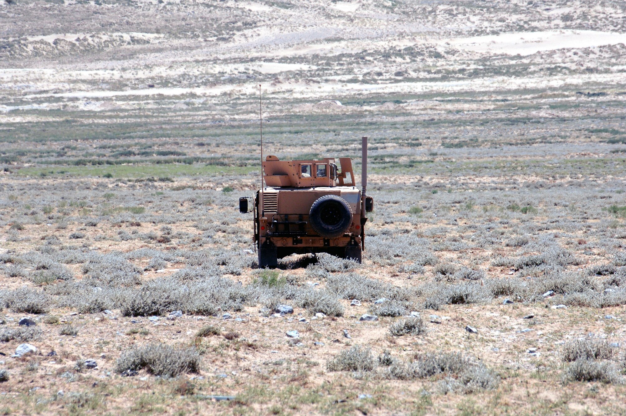 A turret gunner from the 455th Expeditionary Security Forces Squadron, keeps watch on his field of fire from his HUMVEE providing a 360 degree security perimeter around an Explosive Ordnance Disposal team's detonation site outside of Bagram Airfield, Afghanistan June 13. (photo by Staff Sgt. Craig Seals)
