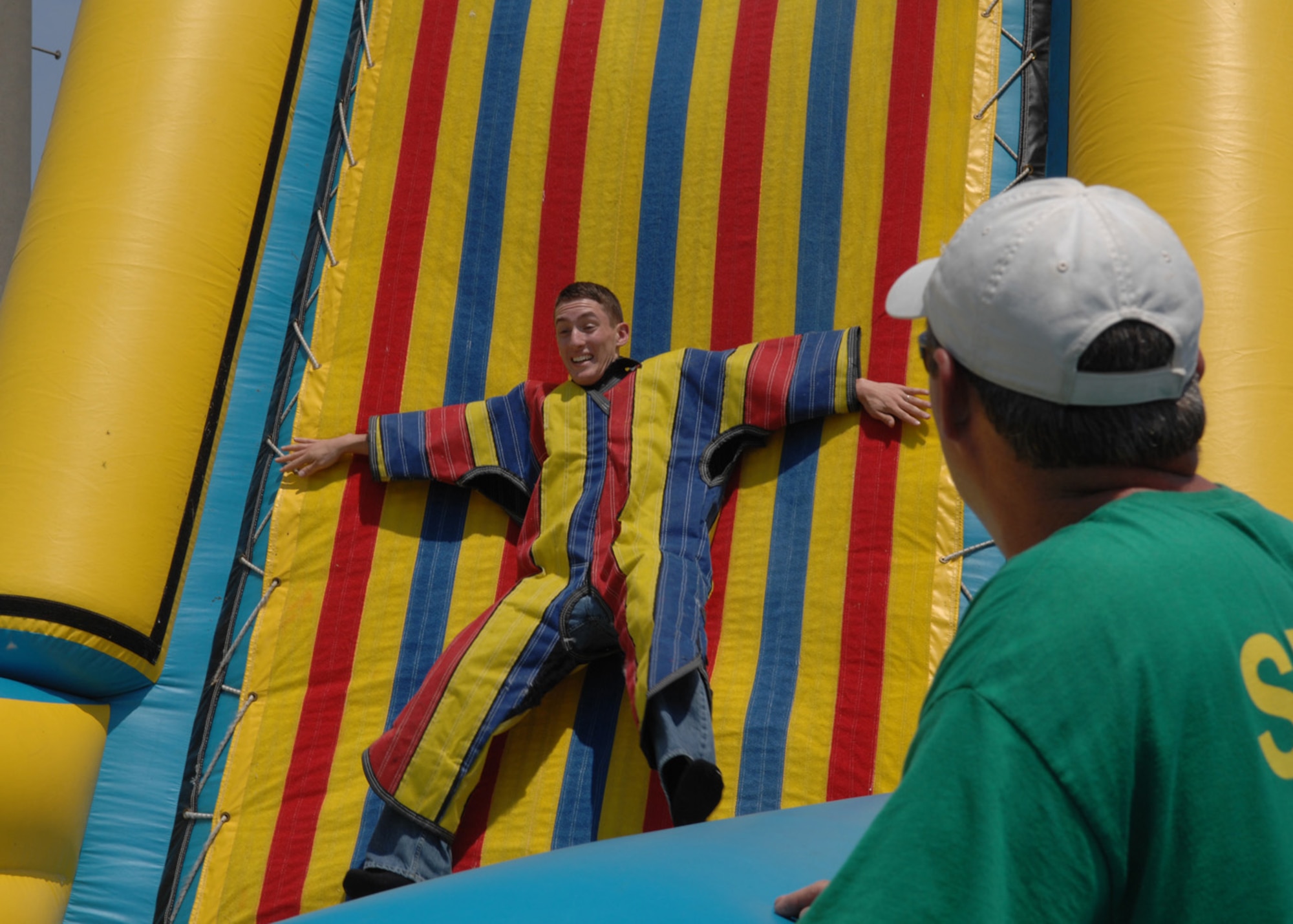 Airman 1st Class Aaron Zeichner, 83rd Communications Squadron gets caught on the "Sticky Wall" while Tim Gayner, a Ragland Production staff member watches from the sidelines during Junior Enlisted Appreciation Day here June 8. The purpose of the event was to thank Langley Airmen for their hard work and dedication. (U.S. Air Force photo/Staff Sgt. Katrina Shellman)