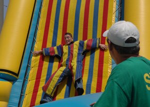 Airman 1st Class Aaron Zeichner, 83rd Communications Squadron gets caught on the "Sticky Wall" while Tim Gayner, a Ragland Production staff member watches from the sidelines during Junior Enlisted Appreciation Day here June 8. The purpose of the event was to thank Langley Airmen for their hard work and dedication. (U.S. Air Force photo/Staff Sgt. Katrina Shellman)