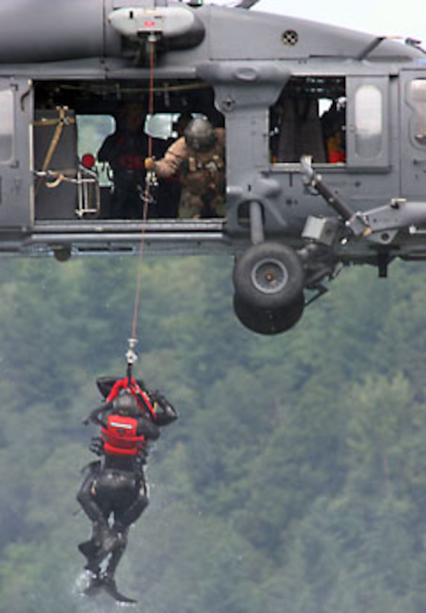 Pararescuemen from the 304th Rescue Squadron are hoisted 25 feet in the air and out of the Columbia River near Portland, Ore. by a HH-60 Pavehawk helicopter from Davis-Monthan Air Force Base, Ariz. during a water rescue training exercise June 11, 2007.  The PJs use these skills to rescue Airmen, Sailors, Soldiers and Marines during contingencies operations overseas, and civilians during humanitarian missions and rescues overseas and in the U.S. (U.S. Air Force Photo/Ruby Zarzyczny)
