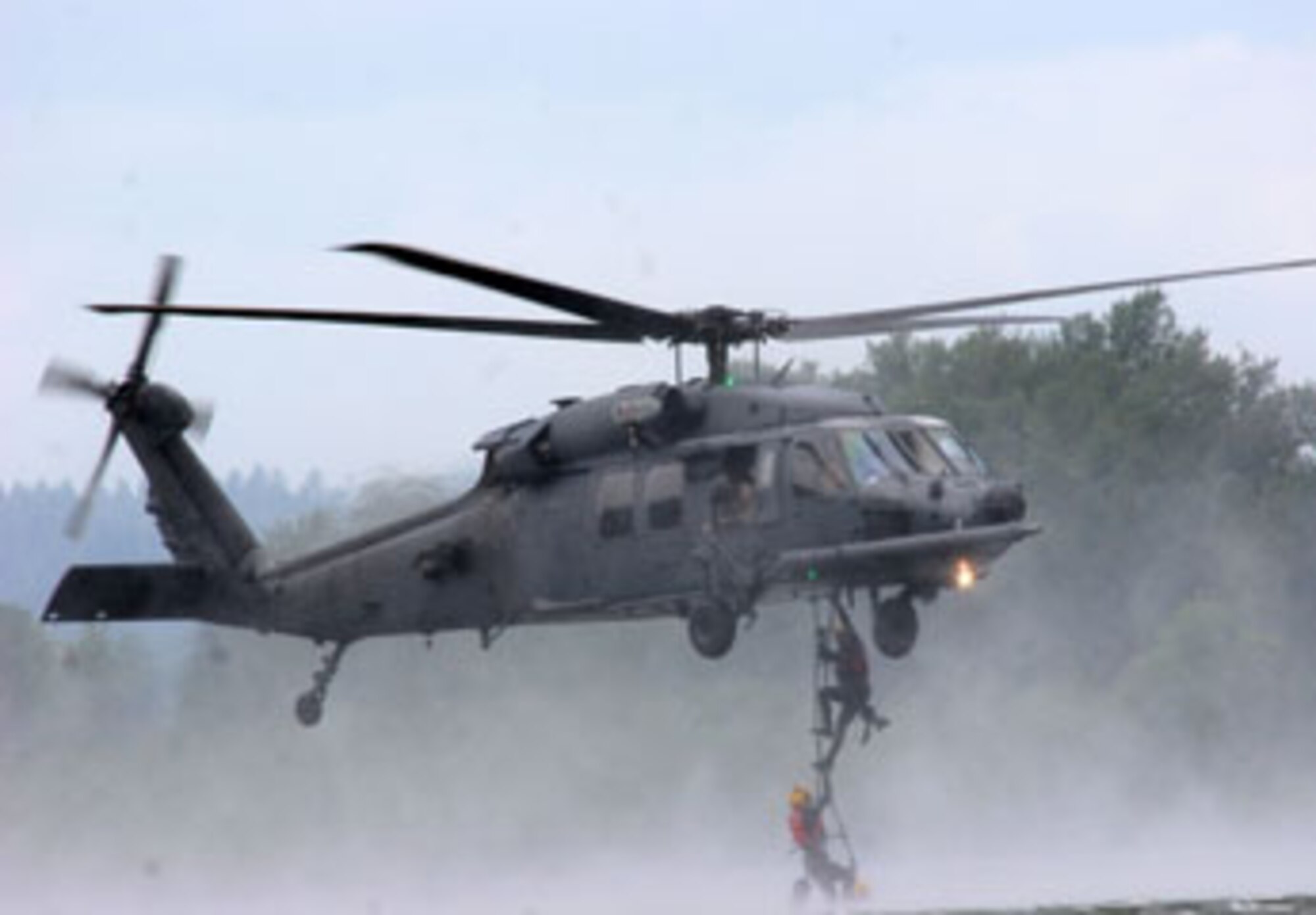 In the Columbia River near Portland, Ore. pararescuemen from the 304th Rescue Squadron climb a rope ladder out of the river and into a HH-60 Pavehawk helicopter from Davis-Monthan Air Force Base, Ariz., June 11, 2007.  The PJs continuously practice these water rescue techniques to maintain their readiness for when they are called to rescue stranded military members during contingency operations or civilians here at home.  (U.S. Air Force Photo/Ruby Zarzyczny)
