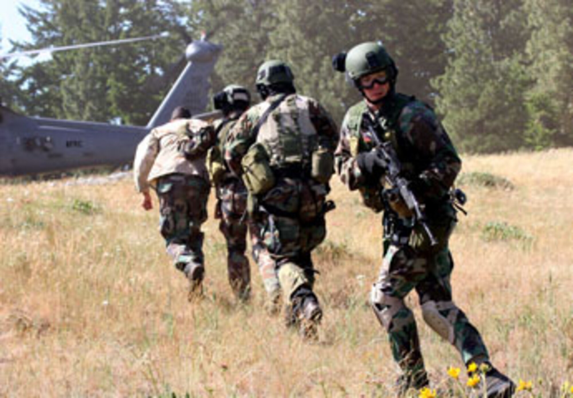 A team of 304th Rescue Squadron pararescuemen redeploy to a waiting 305th Rescue Squadron HH-60 Pavehawk helicopter after recovering a stranded military member during a mountain rescue training exercise near Hood River, Ore. June 9, 2007.  The PJs commitment to training and self-sacrifice to save lives reaffirms their motto “These things we do that others may live".  Without the PJs and Airmen from the rescue squadrons, thousands of service members and civilians would have been unnecessarily lost in past conflicts and natural disasters.  (U.S. Air Force Photo/Ruby Zarzyczny)