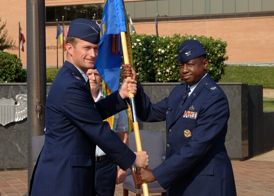 Colonel Mark Brown assumed command of the 14th Mission Support Group Thursday at a ceremony at CAFB's Ceremonial Plaza. He is seen here receiving the unit guideon from Colonel Dave Gerber, 14th Flying Training Wing Commander. (U.S. Air Force Photo by Kenn Brown)