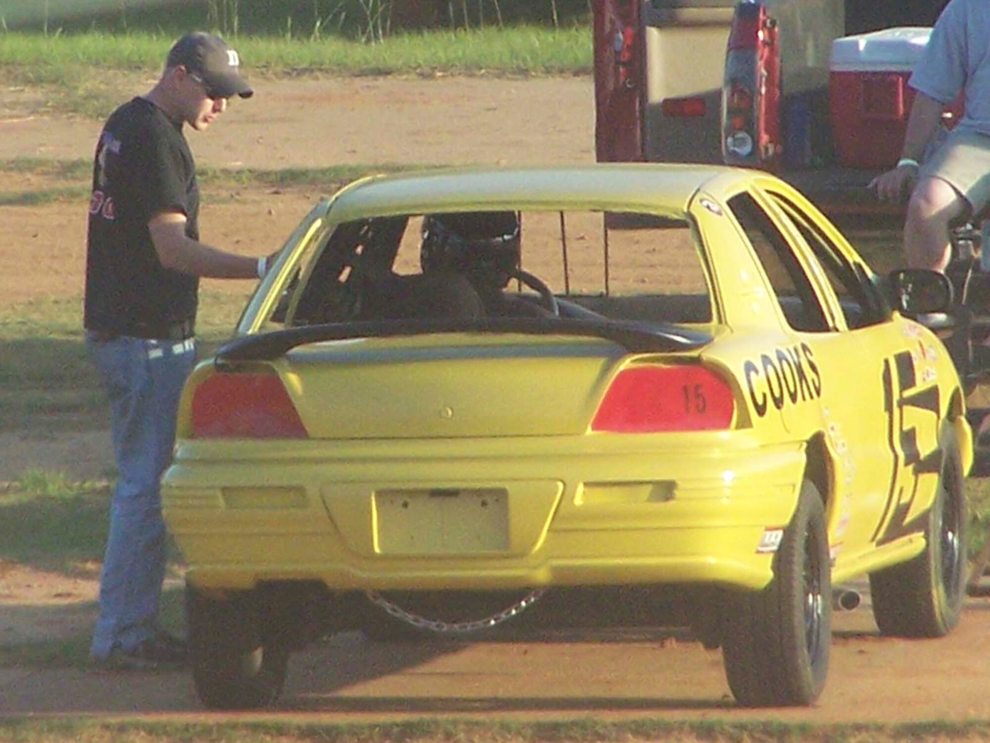 SUMTER, S.C. -- Senior Airman Tommy Dailey, 20th Security Forces Squadron combat arms instructor helps Staff Sgt. Travis Lincoln, 20th SFS combat arms scheduler, prepare for his first race at the Sumter Speedway. Sergeant Lincoln and Tech. Sgt. Corey Becker, 20th Security Forces combat arms assistant NCOIC, recently invested $325 in a car to race in the new "Bomber Class" at the speedway each Saturday at 7:30 p.m. (Courtesy photo)
