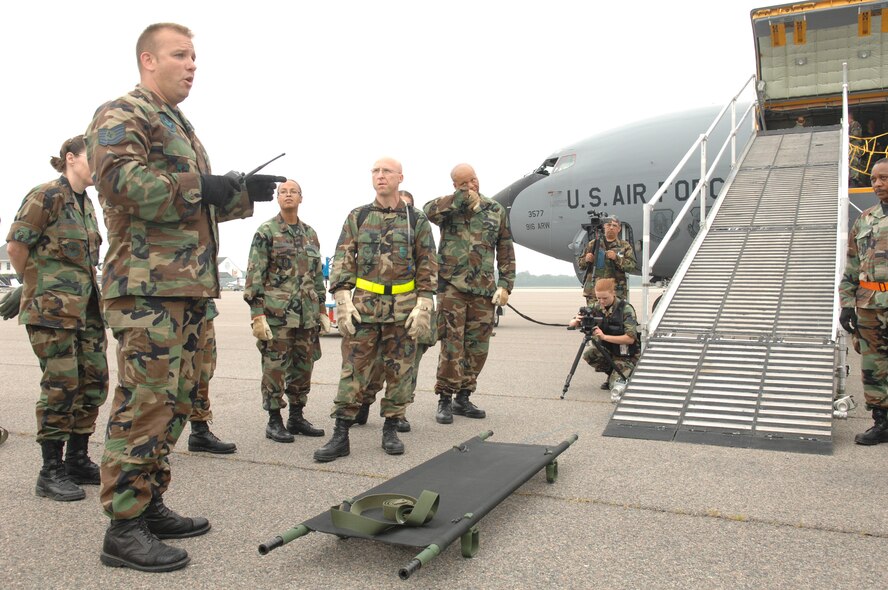 U.S. Air Force TSgt Brian Westington, left, Aeromedical Evacuation Contingency Operations Training Instructor, 381st Training Squadron,Sheppard AFB, Texas, teaches Air Force medical personnel the proper way to carry a litter-bound patient up a PLS (patient loading system) and onto a KC-135 Stratotanker during Golden Medic at Augusta Regional Airport-Bush Field, Ga. on June 12, 2007. Golden Medic is a yearly medical exercise sponsored by the U.S. Army Reserve designed to provide a realistic training experience to participating combat support and service support units, while enhancing the overall training and readiness of Army Reserve and Air Force medical units. (U.S. Air Force photo by Senior Airman Erica J.Knight)(RELEASED)