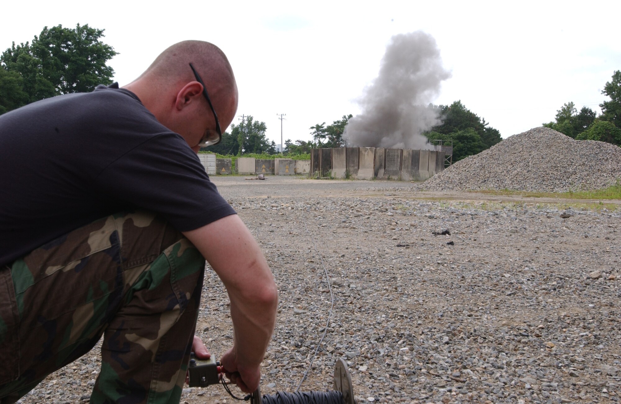 OSAN AIR BASE, Republic of Korea -- Staff Sgt. Ben Ford, 51st Civil Engineering Squadron, detonates Composition C4 through the use of a blasting machine. Sergeant Ford was practicing demolition procedures with several other airmen from Osan's Explosive Ordinance Disposal team. (U.S. Air Force by A1C Jason Epley)