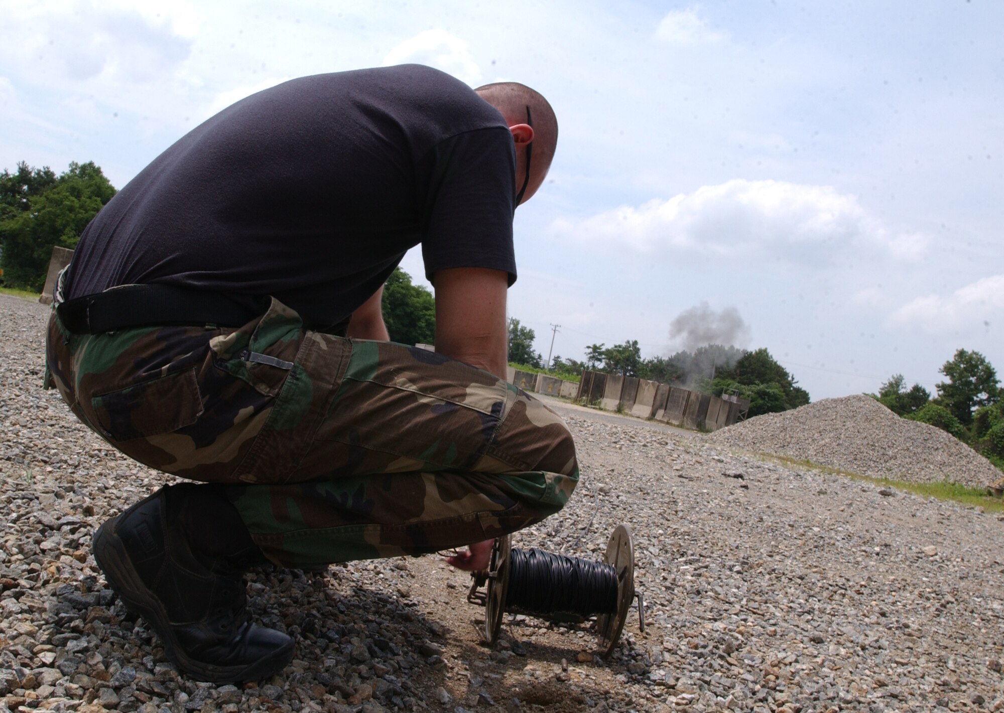 OSAN AIR BASE, Republic of Korea -- Staff Sgt. Ben Ford, 51st Civil Engineering Squadron, detonates composition C4 through the use of a blasting machine. Sergeant Ford was practicing demolition procedures with several other airmen from Osan's Explosive Ordinance Disposal team.  (U.S. Air Force by A1C Jason Epley)