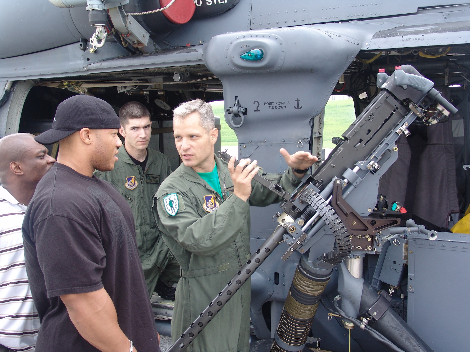 Tech. Sgt. Jerrod Morse briefs Phil Heath on .50-Caliber machine gun helicopter operations in front of a HH-60G rescue helicopter during his tour of the 33rd Rescue Squadron June 8. Mr. Heath was the guest poser at the 2007 Pacific Muscle Classic held at Kadena Air Base, Japan, June 10. 
(U.S. Air Force courtesy photo)                