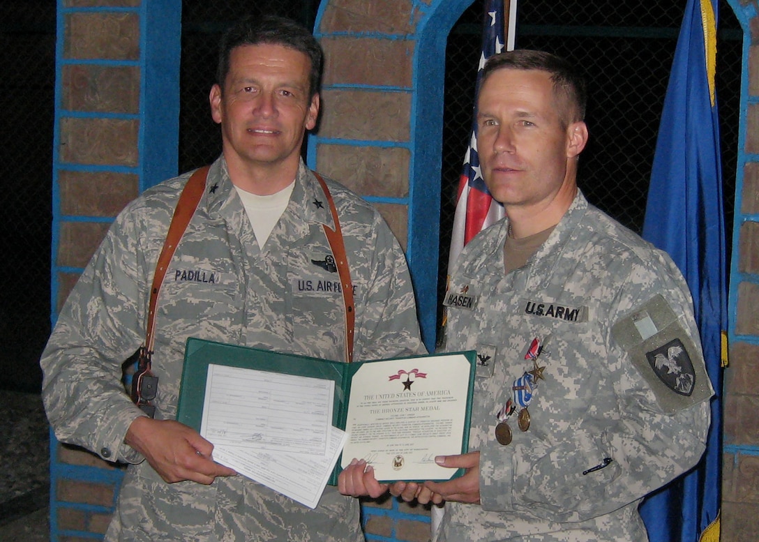 Air Force Brig. Gen. Frank Padilla presents the Bronze Star to Army Col. John Hansen for his work as a mentor to the Afghan National Army Air Corps. Hansen began mentoring the Air Corps as a lieutenant colonel in 2005 and is turning the job over to Padilla. Photo courtesy of Maj. Jeffrey Wilmouth