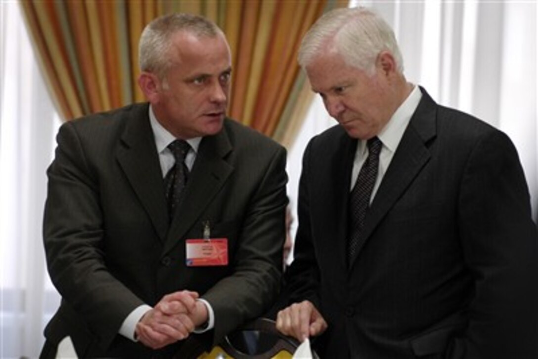 Secretary of Defense Robert M. Gates speaks with the Defense Minister of Poland Aleksander Szczyglo during a working lunch of the NATO-Ukraine Commission as part of the NATO Defense Ministerial in Brussels, Belgium, June 14, 2007.  