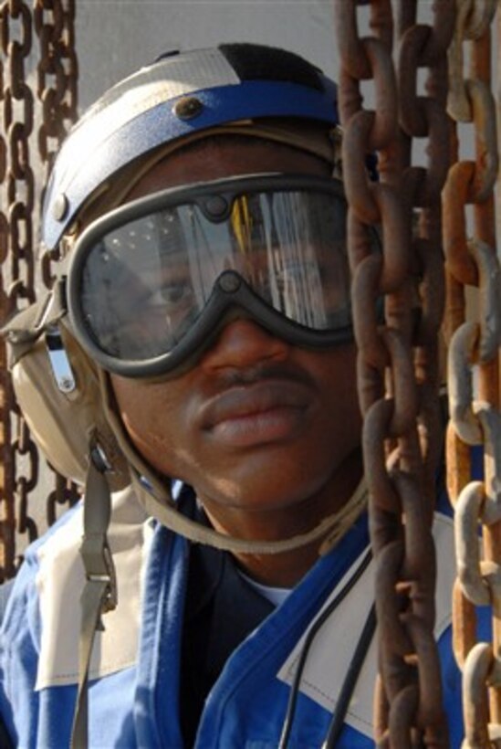 U.S. Navy Seamen Brandan Taylor is surrounded by tie down chains as he stands ready to chock and chain SH-60F Seahawk helicopters landing on the flight deck of the USS Blue Ridge (LCC 19) on June 4, 2007.  The chains keep the aircraft from moving on the deck as the ship operates at sea.  