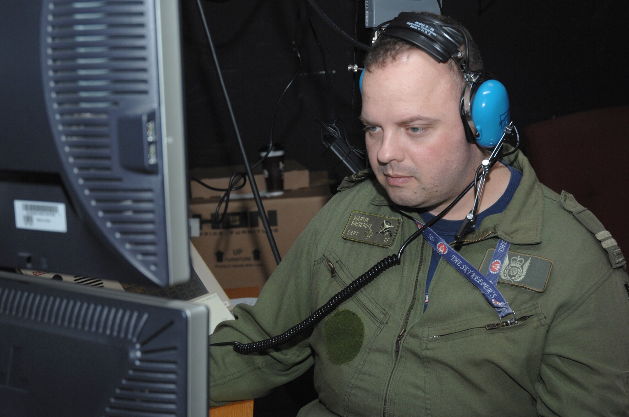 EIELSON AIR FORCE BASE, Alaska -- Capt. Martin Brisebois, 962nd Airborne Air Control Squadron controller, Canadian air force, based in Elmendorf AFB, Alaska, monitors a radar screen during Red Flag-Alaska 07-02, June 14, 2007. Captain Brisebois, along with other controllers, monitors seven frequencies in the back-up control facility for the exercise and provides support for over 67,000 square miles around Eielson AFB, Alaska.  RF-A is a Pacific Air Forces-directed field training exercise for U.S. forces flown under simulated air combat conditions. It is conducted on the Pacific Alaskan Range Complex with air operations flown out of Eielson and Elmendorf Air Force Bases. (U.S. Air Force Photo by Staff Sgt Tia Schroeder) 