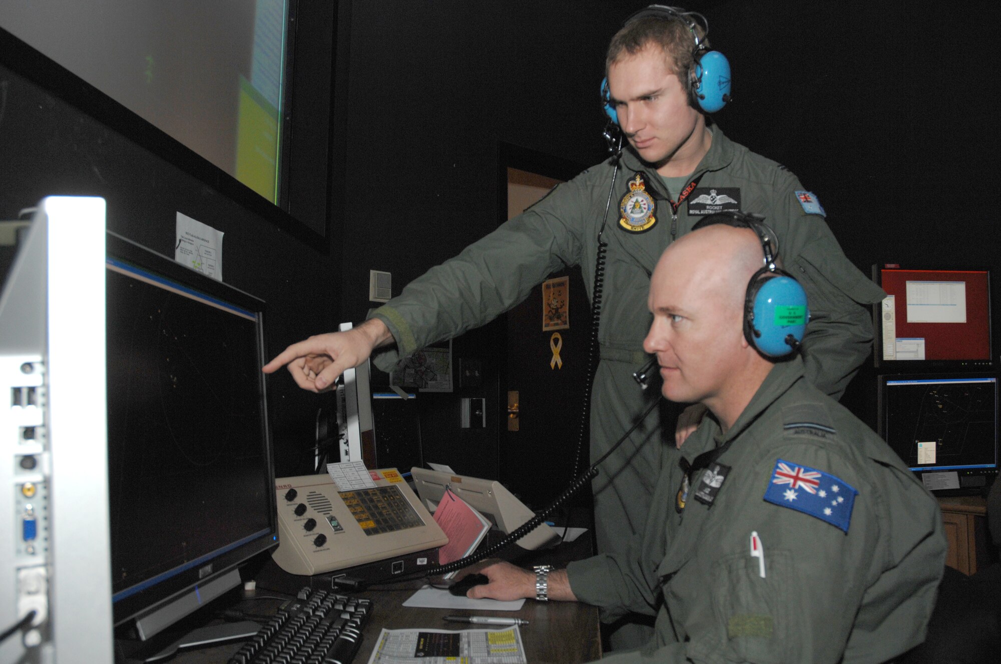 EIELSON AIR FORCE BASE, Alaska -- Flying Officers Murray Ross and Lucas Roston, both of the Royal Australian air force, Williamtown, Australia, monitor a radar screen during Red Flag-Alaska 07-02, June 14, 2007. Flying Officers Ross and Roston, and other weapons controllers, monitor the back-up control facility for the exercise and provide support for over 67,000 square miles around Eielson AFB, Alaska.  RF-A is a Pacific Air Forces-directed field training exercise for U.S. forces flown under simulated air combat conditions. It is conducted on the Pacific Alaskan Range Complex with air operations flown out of Eielson and Elmendorf Air Force Bases. (U.S. Air Force Photo by Staff Sgt. Tia Schroeder) 
