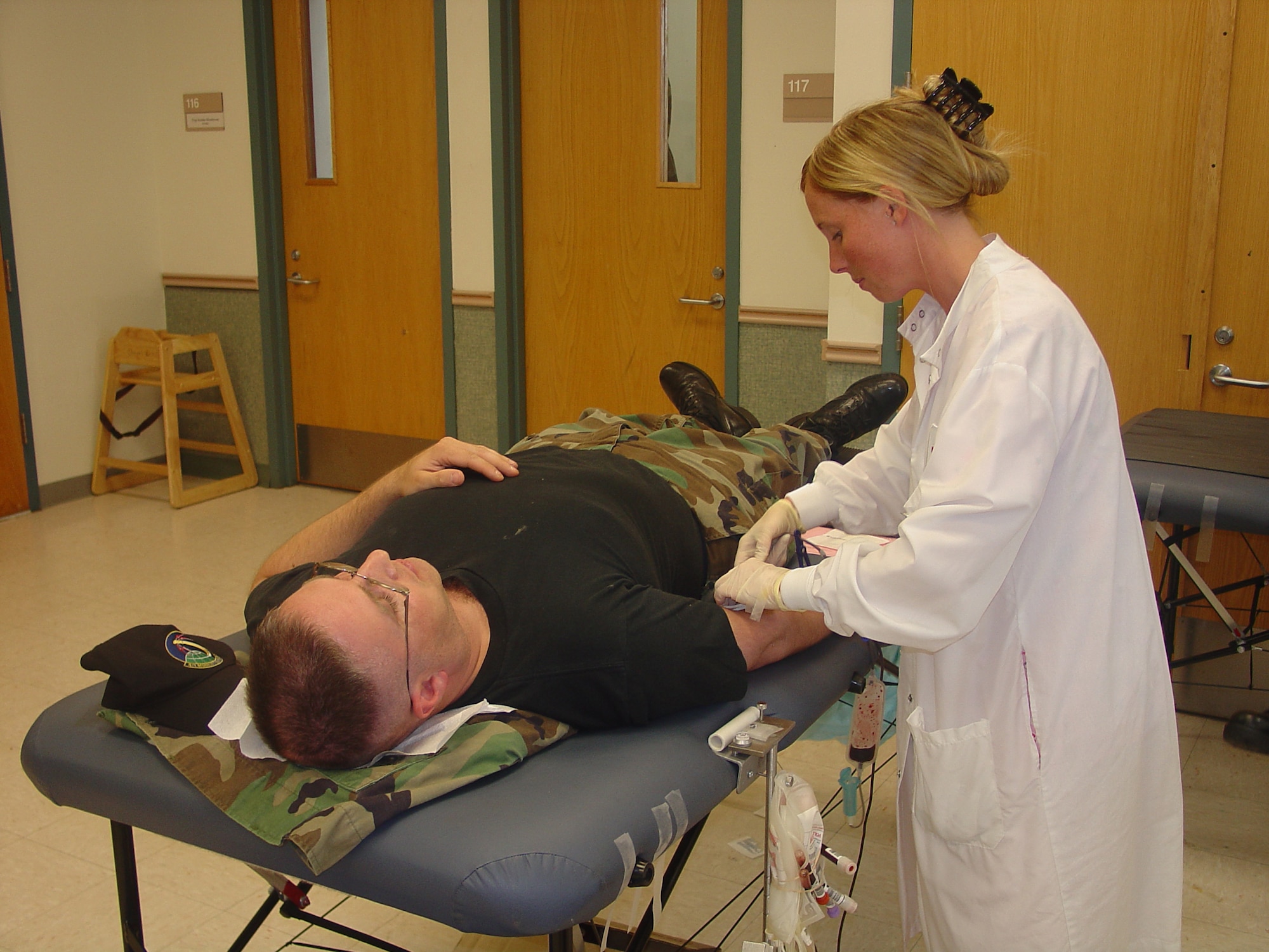 Master Sgt. David Kanterman, Air Mobility Battlelab communications concept manager, donates blood with assistance from Kerri Ward, Red Cross donor collection assistant, at the Chapel here June 15. 