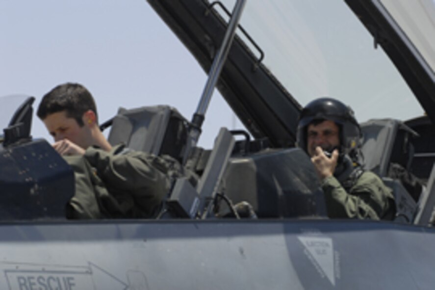 Capt. Hank McKibban, 61st Fighter Squadron instructor pilot, prepares to fly Phoenix Mayor Phil Gordon in an F-16 orientation flight June 8. The purpose of the flight was to promote understanding to community leaders of Luke’s F-16 training mission and the airspace requirements to accomplish it. Members of the 61st Fighter Squadron gave Mayor Gordon the call sign, “Flash.” Photo by Staff Sgt. David Miller.