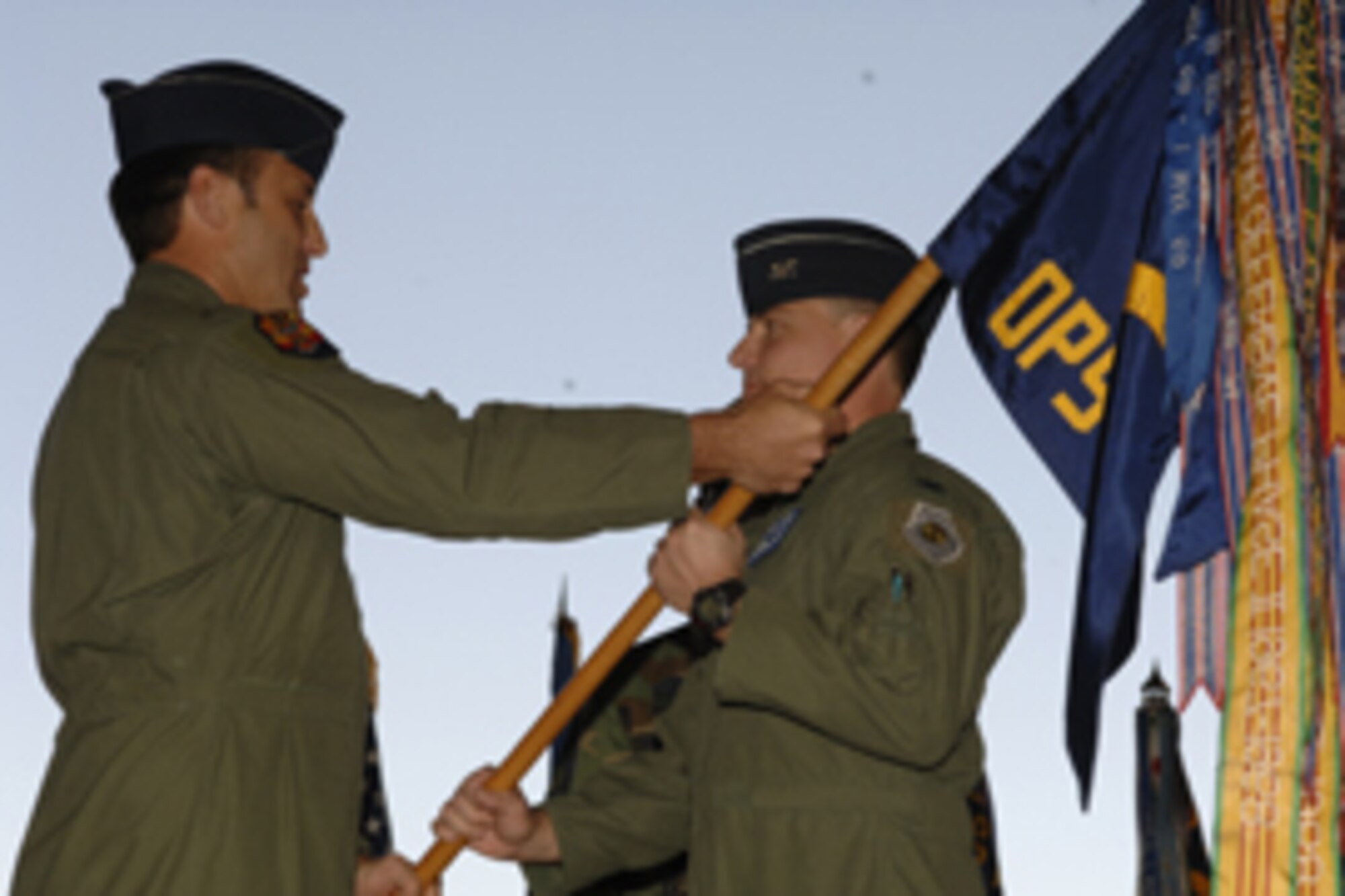 Col. Robert Givens, 56th Operations Group commander, receives the OG guidon from Brig. Gen. Tom Jones, 56th Fighter Wing commander, during a ceremony June 1 in Hangar 913. Colonel Givens assumed command from Col. Timothy Strawther.  Photo by Airman 1st Class David Bulkley
