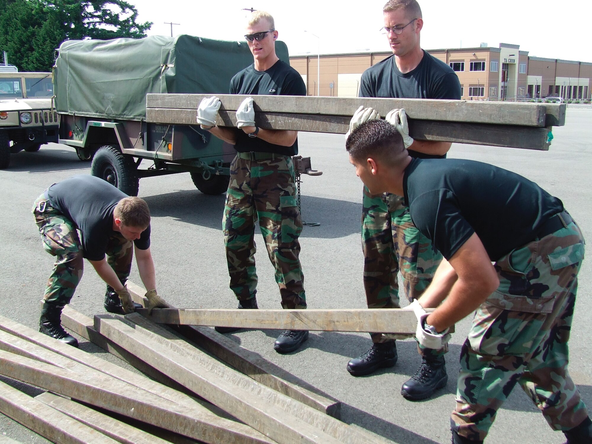 MCCHORD AIR FORCE BASE, Wash. -- From right, Staff Sgt. George Parker, Tech. Sgt. Scott Winchell and Senior Airman Jeffrey Winters, all from the 62nd Aerial Port Squadron, help push a Humvee as part of Rodeo training, Tuesday. The eight-person 62nd APS Rodeo team is training for the Rodeo aerial port challenge course along with other competition events in Air Mobility Command’s Rodeo 2007. Rodeo will be held here July 21 to 28. (U.S. Air Force Photo by Capt. Suzanne Ovel)
