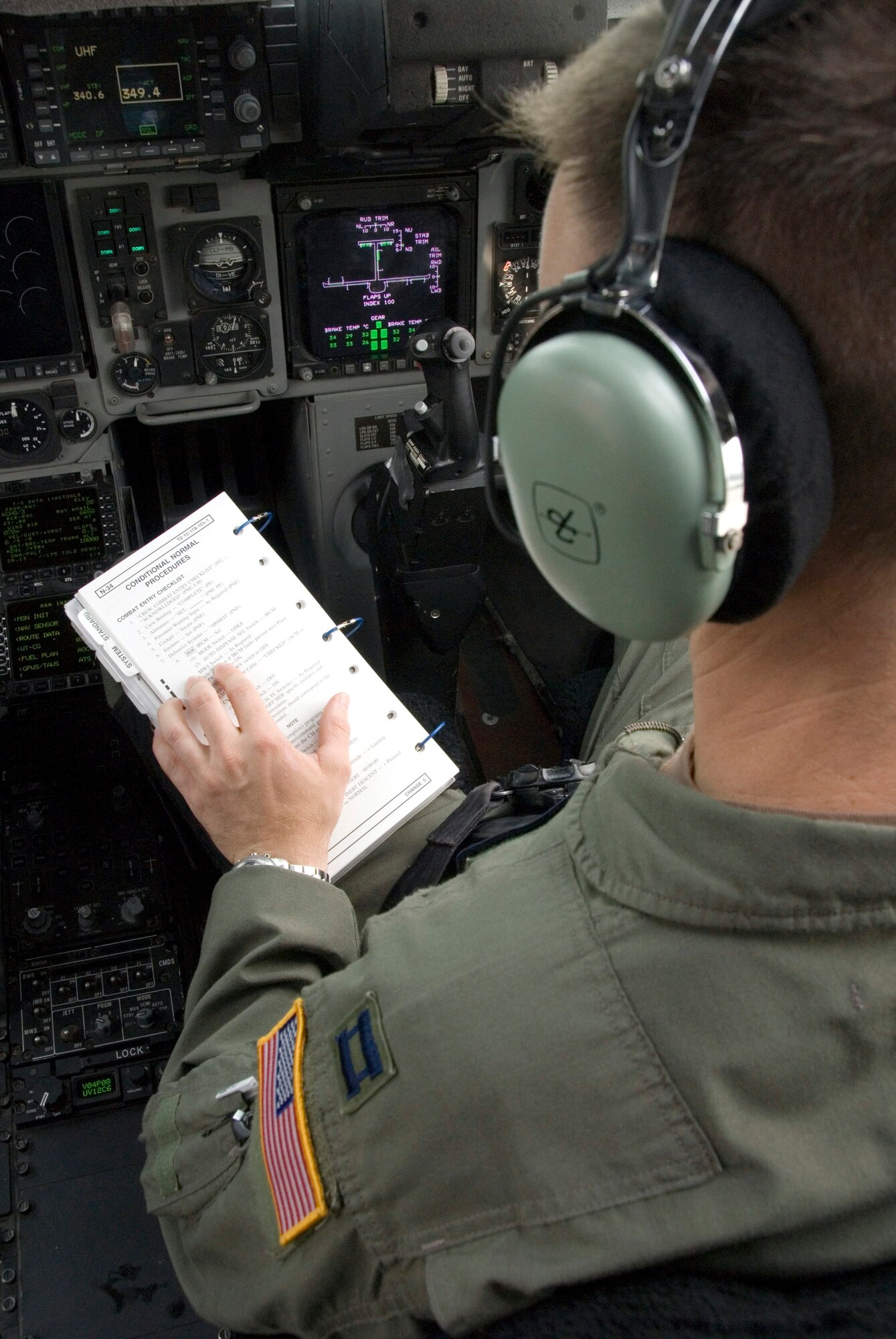 Capt. Jason Hughes reviews a checklist during a preflight check of a C-17 Globemaster III at Charleston Air Force Base, S.C., prior to takeoff.  Captain Hughes is a pilot in the 17th Airlift Squadron.  (U.S. Air Force photo/Senior Airman Sam Hymas)