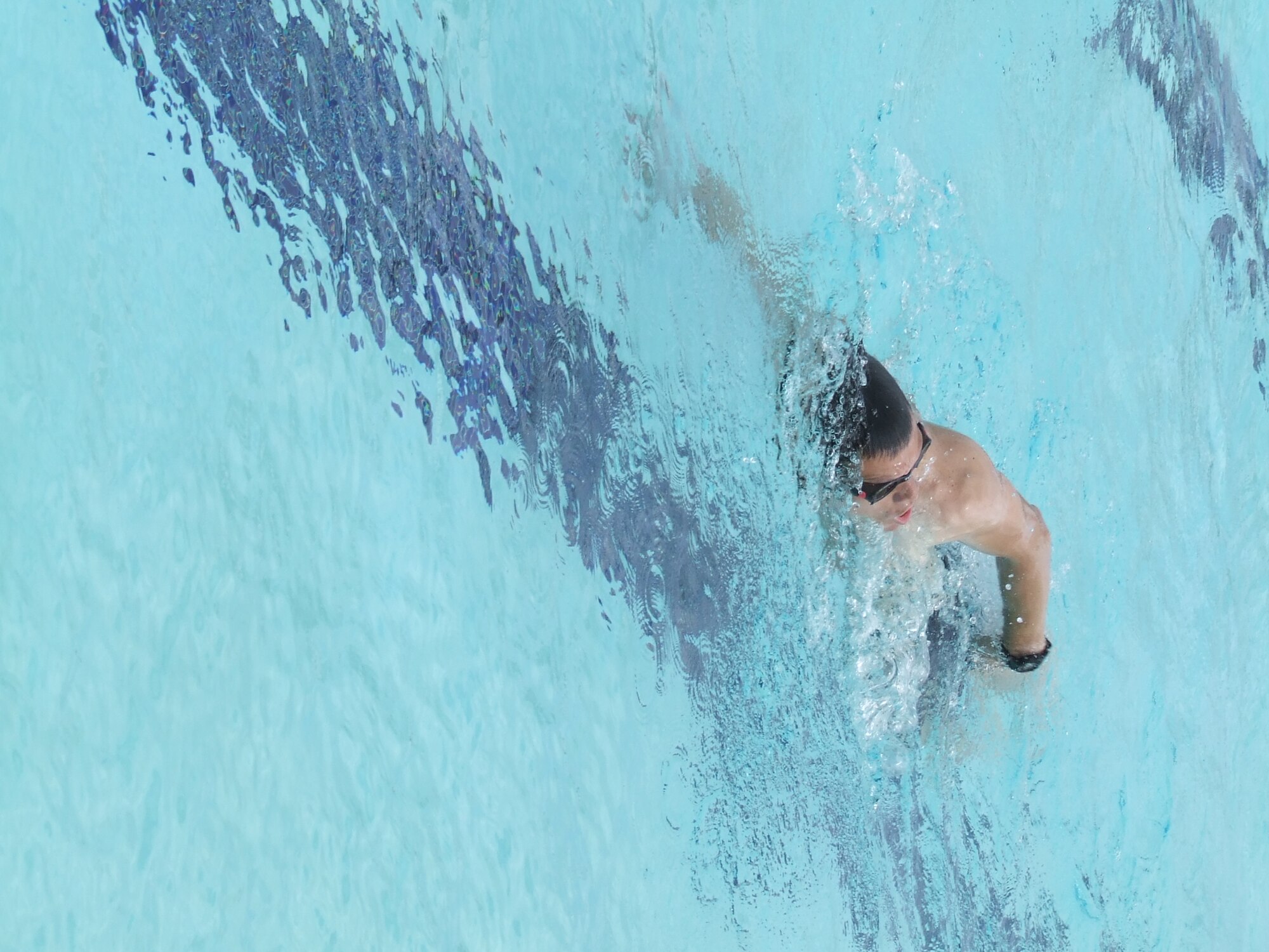 MCCHORD AIR FORCE BASE, Wash. -- Capt. Michael Masuda, 4th Airlift Squadron, swims laps in the base pool, Wednesday. The base pool opened for the season Memorial Day weekend and will close Labor Day weekend.(U.S. Air Force Photo by Tyler Hemstreet)