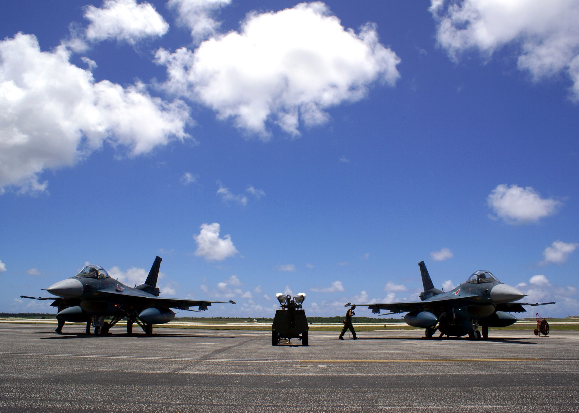 Two Mitsubishi F-2s sit on the flightline June 13 at Andersen Air Force Base, Guam, awaiting takeoff. The F-2s are part of a historic Japan Air Self Defense Force deployment from Misawa Air Base, Japan. This Cope North exercise is the first time the F-2s will deploy outside of Japan, and the first time they will drop live munitions on a fixed target. (U.S. Air Force photo/Marine Cpl. Ashleigh Bryant)