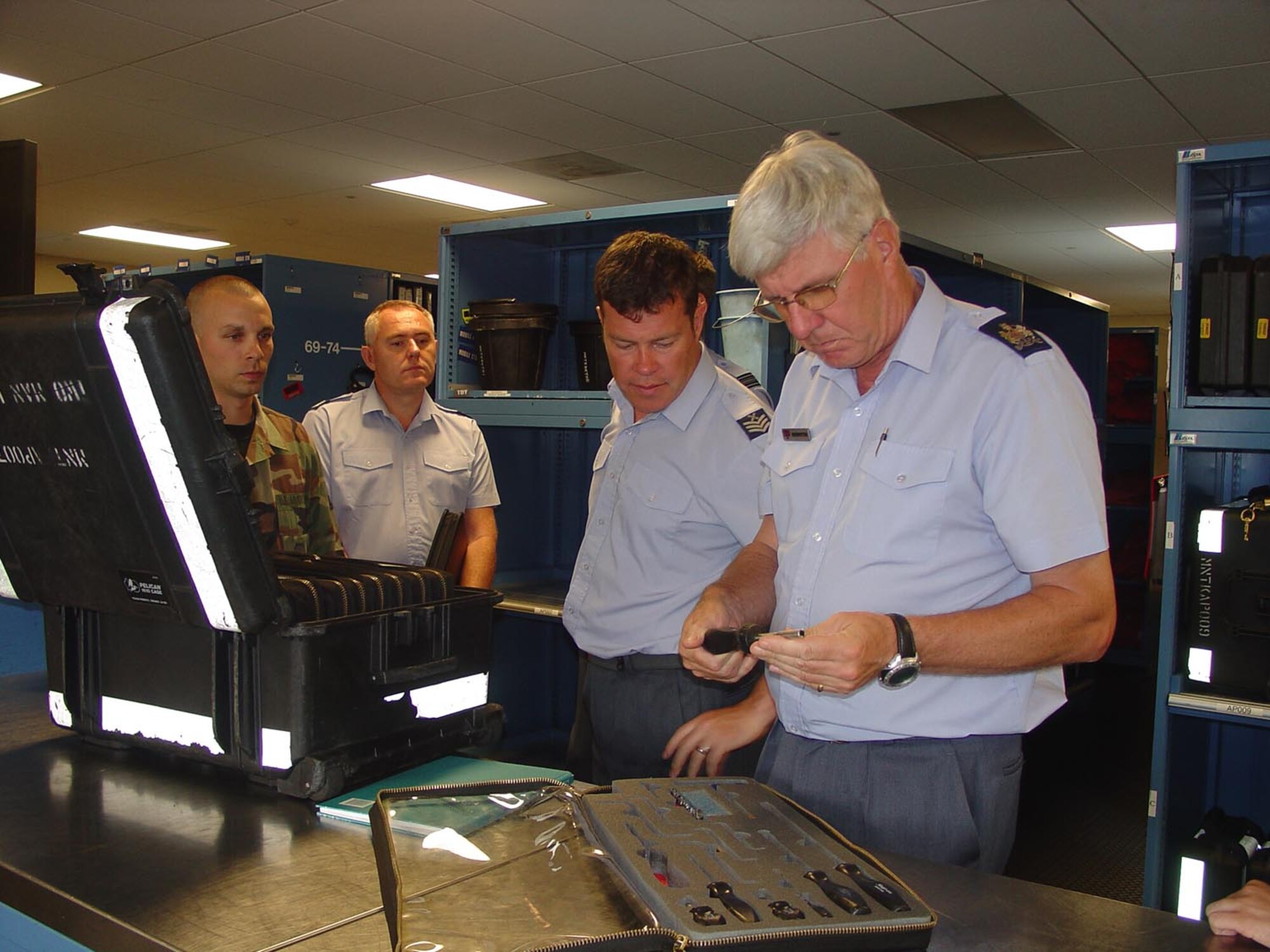 Staff Sgt. Ellwood WItt, 305th Aircraft Maintenance Squadron consolidated tool kit technician, shows members of the Royal Air Force an example of a CTK. Four members from RAF Brize Norton conducted a site visit Tuesday and Wednesday, to view C-17 maintenance and life support operations. The RAF, a coalition partner in the Global War on Terrorism, currently flies four C-17s.  “We are comparing and contrasting how we do business and how they do business,” said Capt. Wendi Duffy, 514th Aircraft Maintenance Squadron and lead for the RAF C-17 coalition visit. (U.S. Air Force photo by Senior Airman Rachel Martinez)
