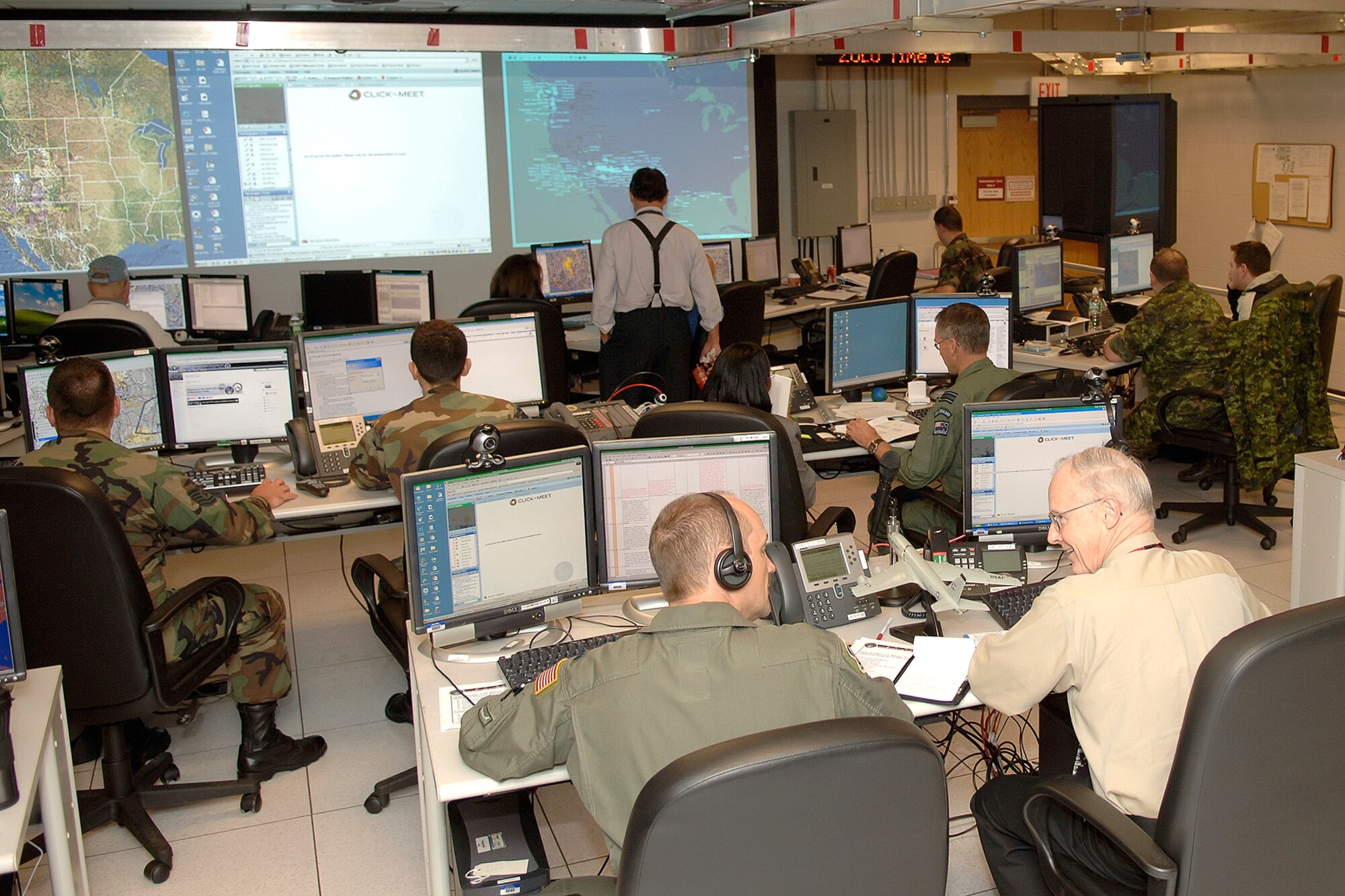 U.S. Air Force active-duty, Guard and Reserve members join coalition forces on the floor of the mini-combined air operations center at Hanscom Air Force Base, Mass., during the ongoing Coalition Warrior Interoperability Demonstration 2007. (Air Force photo)