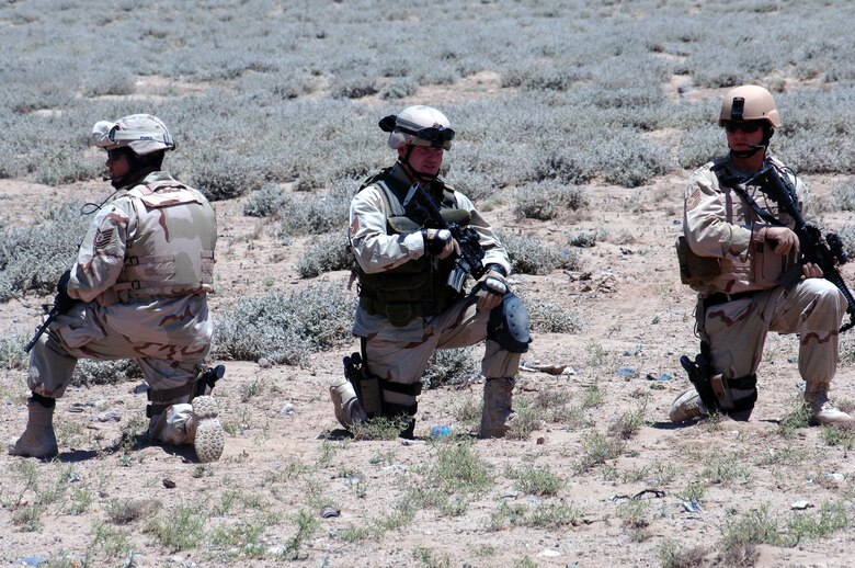 Tech. Sgts. Rogelio Ponce, Joseph Ilsley and Christopher Hann maintain a 360-degree security perimeter around an explosive ordnance disposal team's detonation site June 13 outside of Bagram Air Base, Afghanistan. The sergeants, with the 455th Expeditionary Security Forces Squadron, are deployed from Vandenberg Air Force Base, Calif.  (U.S. Air Force photo/Staff Sgt. Craig Seals)