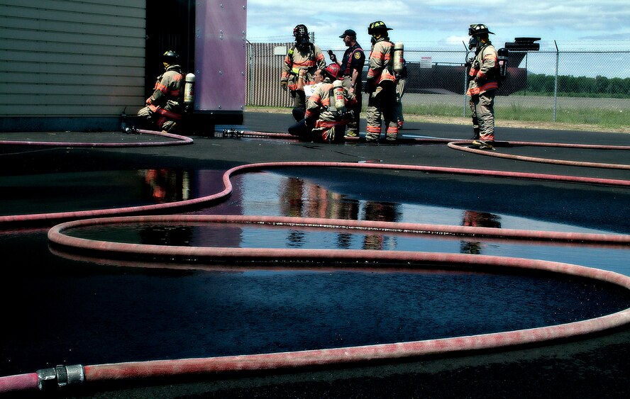 Westover firefighters christened the base's new "smoke house," a training facility designed to simulate the temperatures and visibility of an actual building fire, here on June 4. Local firefighters from Chicopee, Mass. also joined in on the event.
