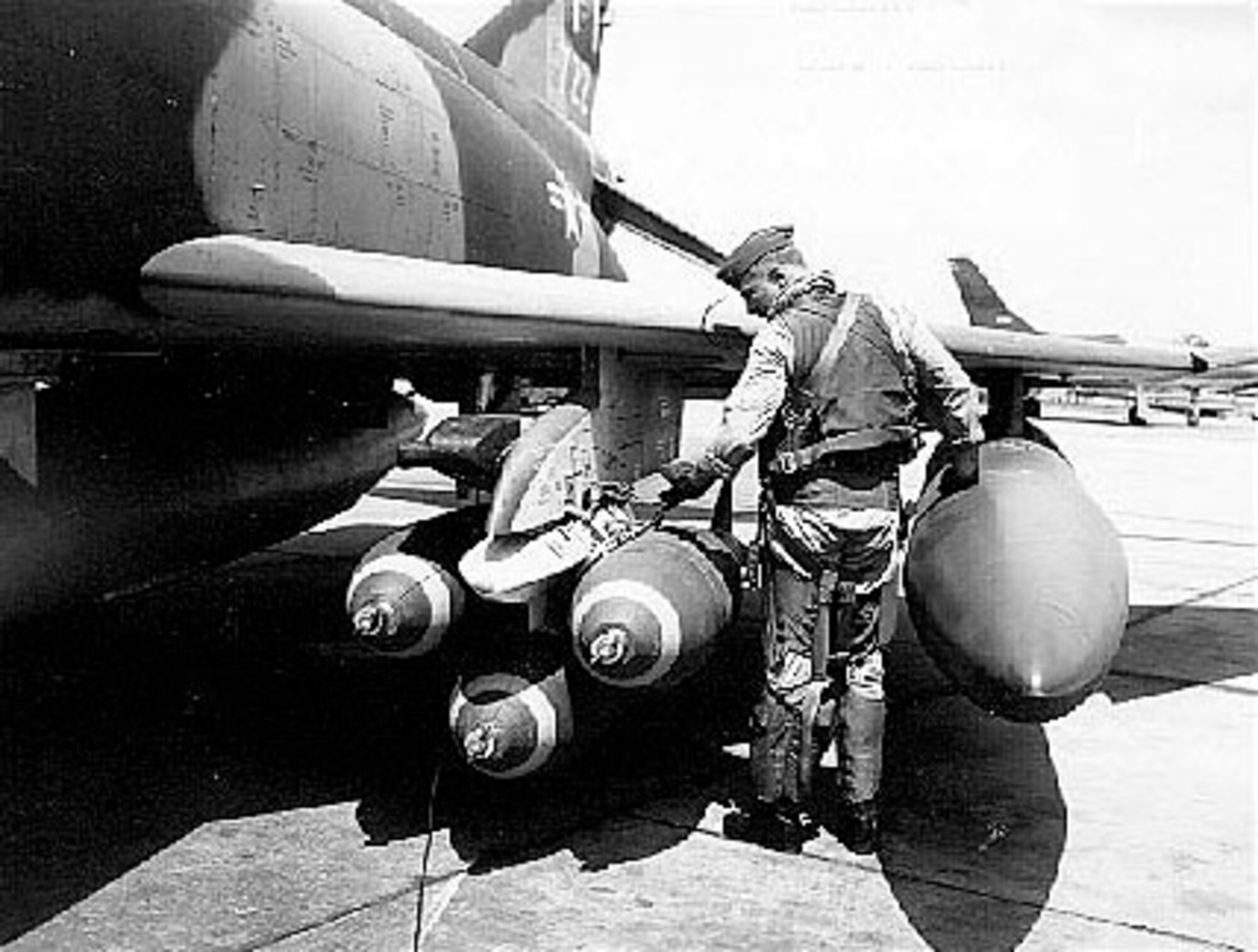 Col. Robin Olds checks munitions on his F-4C Phantom, Scat XXVII, prior to a mission.  He was the commander of the 8th Tactical Fighter Wing at Ubon Air Base, Thailand, and was credited with shooting down four enemy MiG aircraft in aerial combat over North Vietnam.  (U.S. Air Force photo)