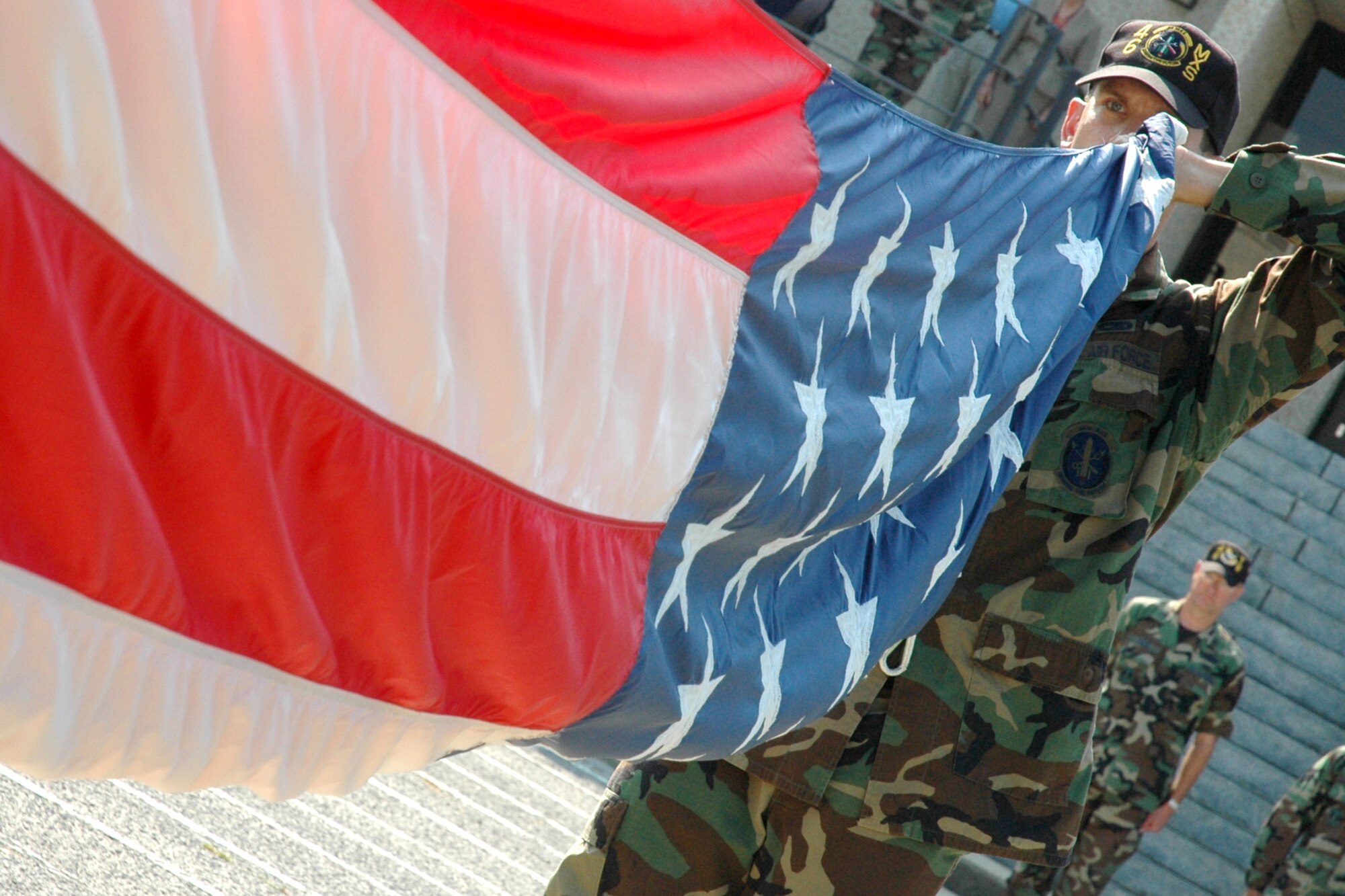 EGLIN AIR FORCE BASE, Fla. -- Staff Sgt. Randall Gentry, 46th Maintenance Squadron, prepares to fold the American Flag during base retreat at the Air Armament Center headquarters building June 14. The rest of the Airmen in the wing were in formation near the flag pole during the ceremony. June 14 is historically Flag Day, a day that Americans are asked to remember what the flag represents and to pay their respect to it. (U.S. Air Force photo by Staff Sgt. Mike Meares)