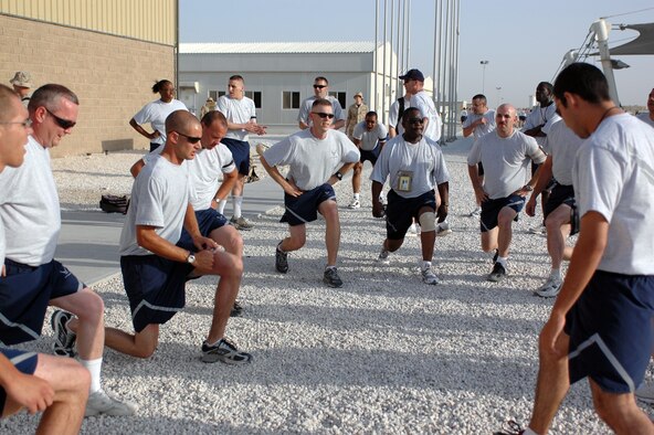 Airmen from the 379th Expeditionary Civil Engineer Squadron perform lunges together during a squadron event called “The Great Race.” The event integrated the squadron’s flights, teaching them to work together to find eight clues stashed around Coalition Compound while incorporating physical fitness. (U.S. Air Force photo by Senior Airman Clark Staehle)
