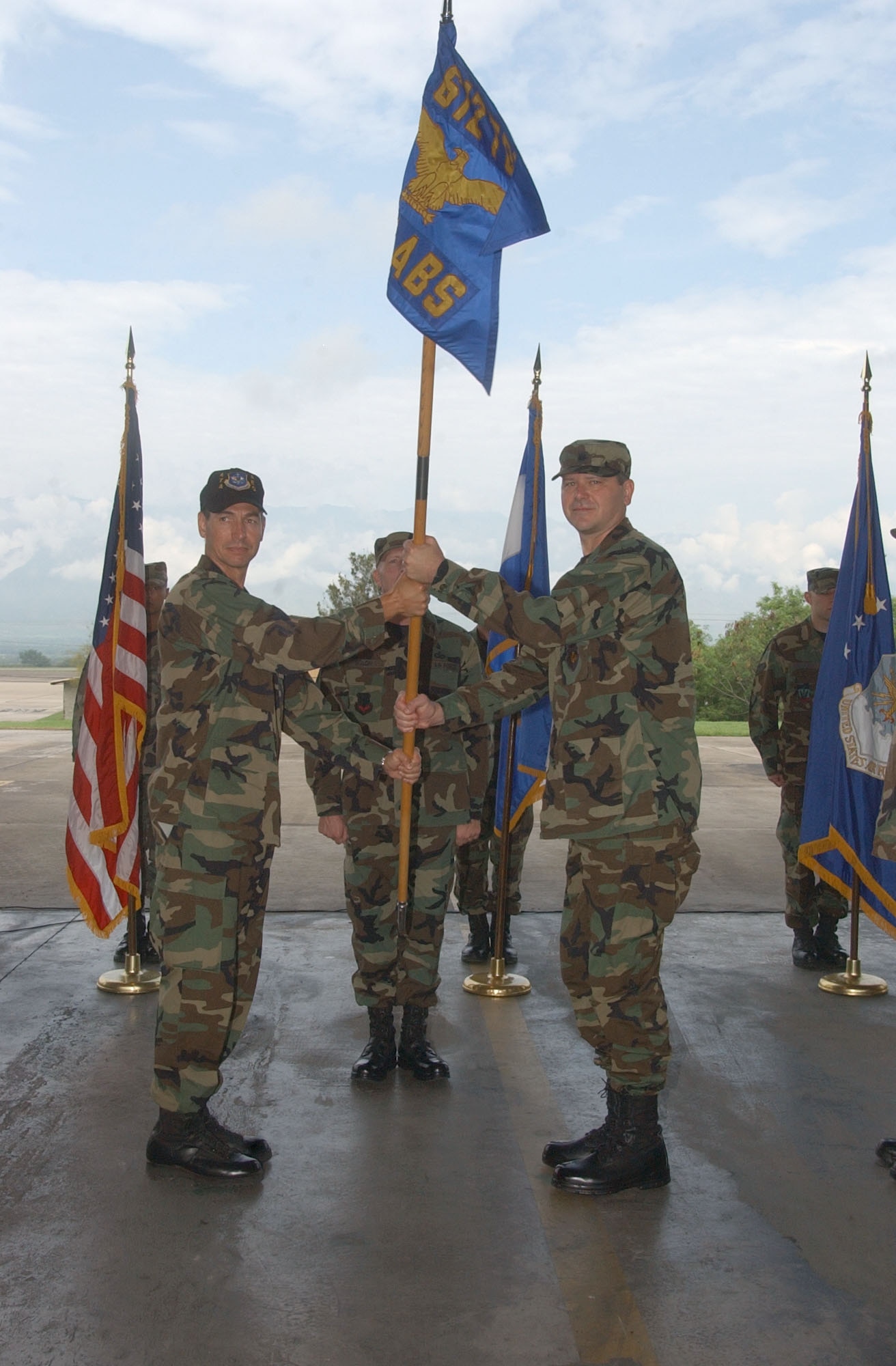By accepting the 612th Air Base Squadron guidon from Col. Mark Mouw, 474th Operations Group commander, left, Lt. Col. Randy Vogel assumes command of Air Force Forces at Soto Cano Air Base, Honduras June 15. Colonel Vogel was previously the 55th Wing director of staff at Offutt Air Force Base, Neb. U.S. Air Force photo by Martin Chahin.             