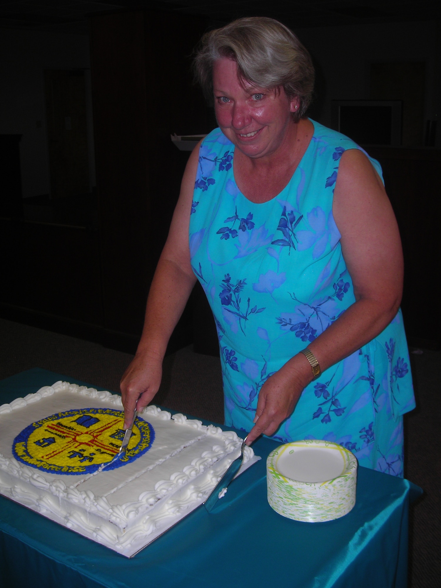 Ms. Laura Meredith, 49th Fighter Wing Sexual Assault Response Coordinator, cuts cake during the second annual SARC birthday bash. The SARC, along with 14 volunteer victim advocates run the sexual assualt prevention program here. (U.S. Air Force photo by Senior Airman Terri Barriere)