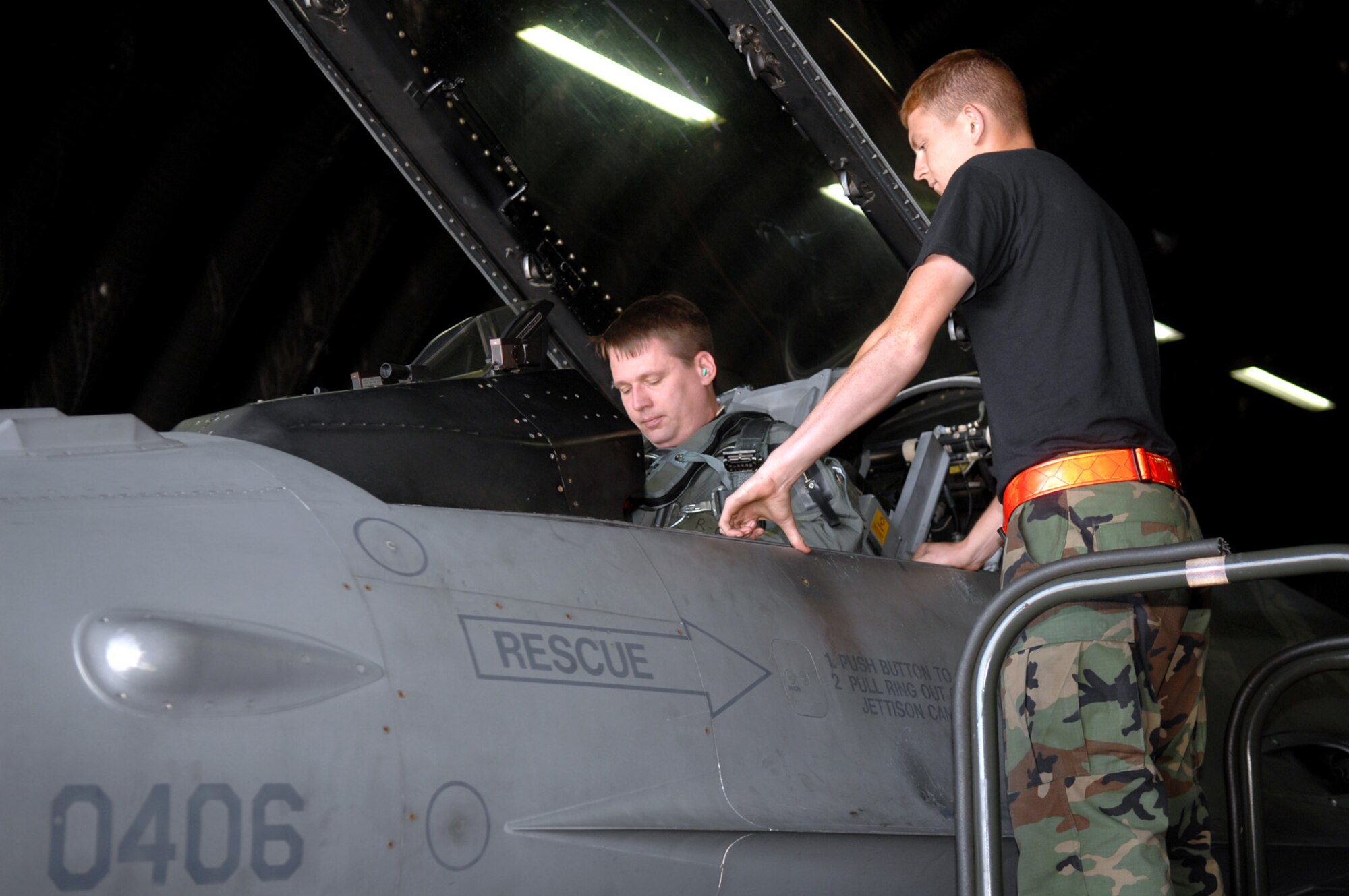 SPANGDAHLEM AIR BASE, GERMANY -- Airman 1st Class Daren Cantu, 52nd Aircraft Maintenance Squadron, assists Lt. Col. Bartz "Weeds" Sykes, 22nd Fighter Squadron, with some last minute tasks as he prepares to depart Spangdahlem AB, Germany, en route to Nellis Air Force Base, N.V., due to the base’s runway closure.  (US Air Force photo/Senior Airman Josie Kemp) 